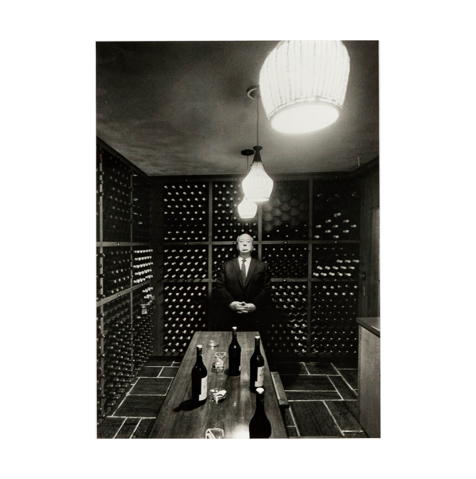 Phil Stern, 1919-2014, Alfred Hitchcock (In White Cellar): silver gelatin print c.1960, signed, dated, titled, and stamped verso Sight: 18 1/4 x 13 in. (46.4 x 33 cm.) Frame: 31 1/4 x 25 1/4 in. (79.4 x 64.1 cm.) Provenance: The Mark Canton Collection ? From