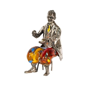 An Italian Sterling and Colored Glass Figure of a Seated Man
