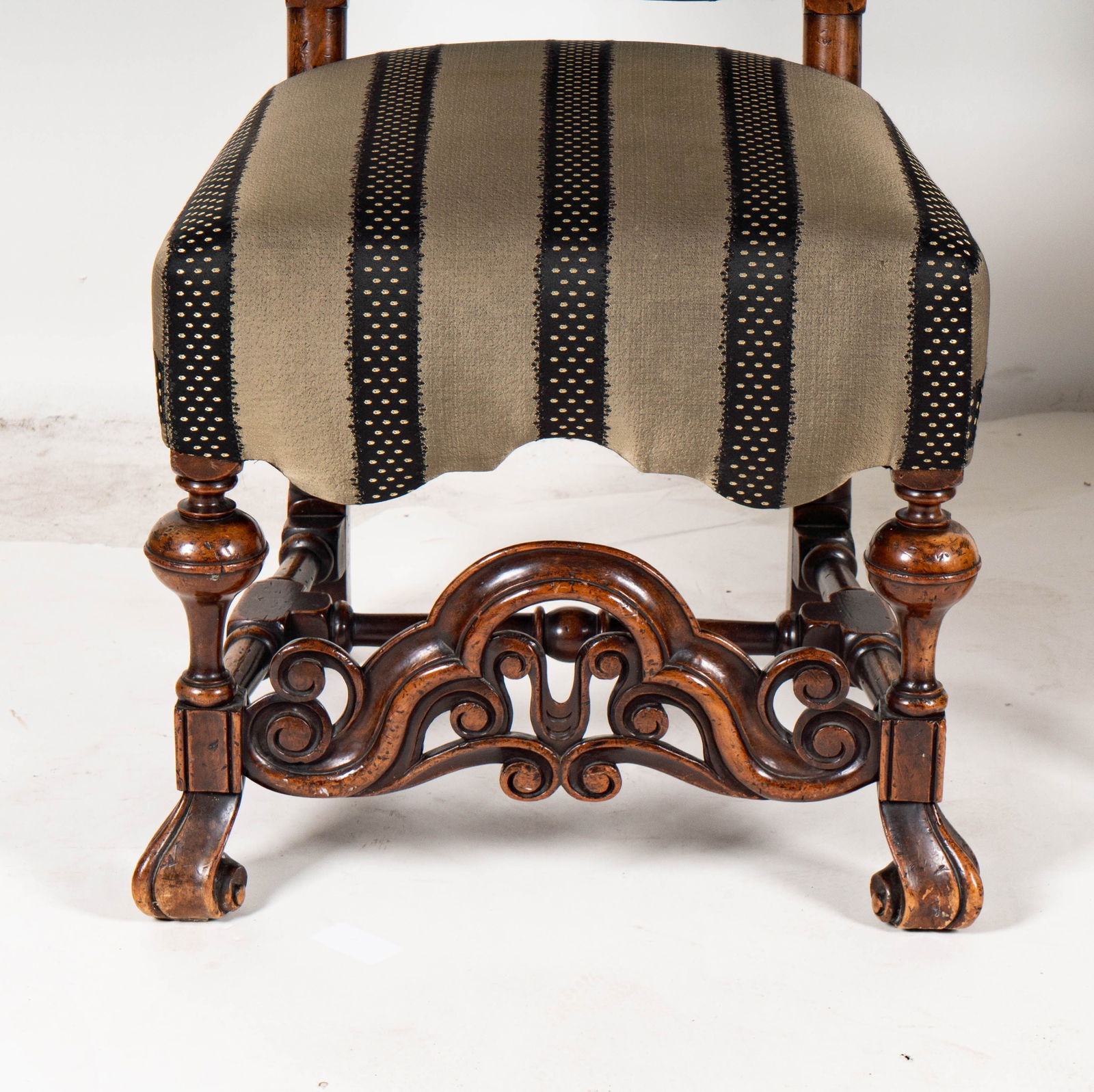 A Pair of Jacobean-Style Carved Side Chairs: covered in striped fabric 52 x 25 x 19 in. (132.1 x 63.5 x 48.3 cm.) Seat height: 19 in. (48.3 cm.)