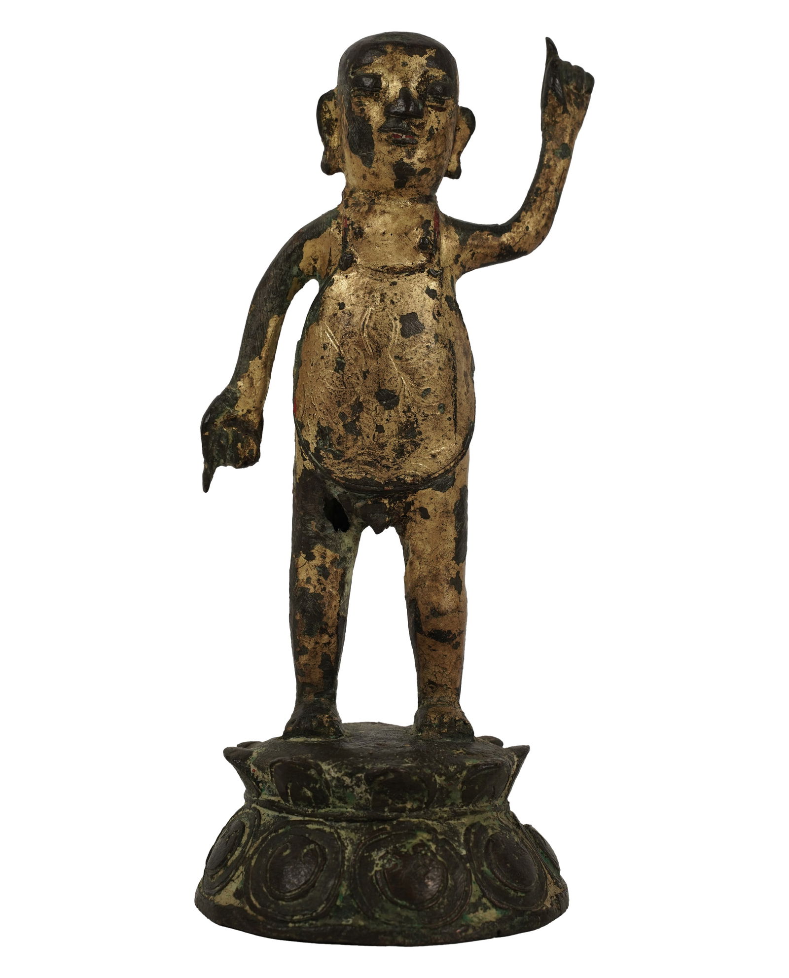 A Tibetan Gilt Bronze Figure of Buddha: depicted standing, with left arm raised, on a lotus 8 in. (20.3 cm.) high