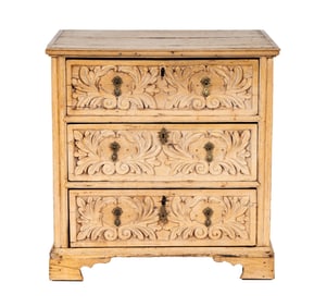 A Carved Bleached Wood Chest of Drawers