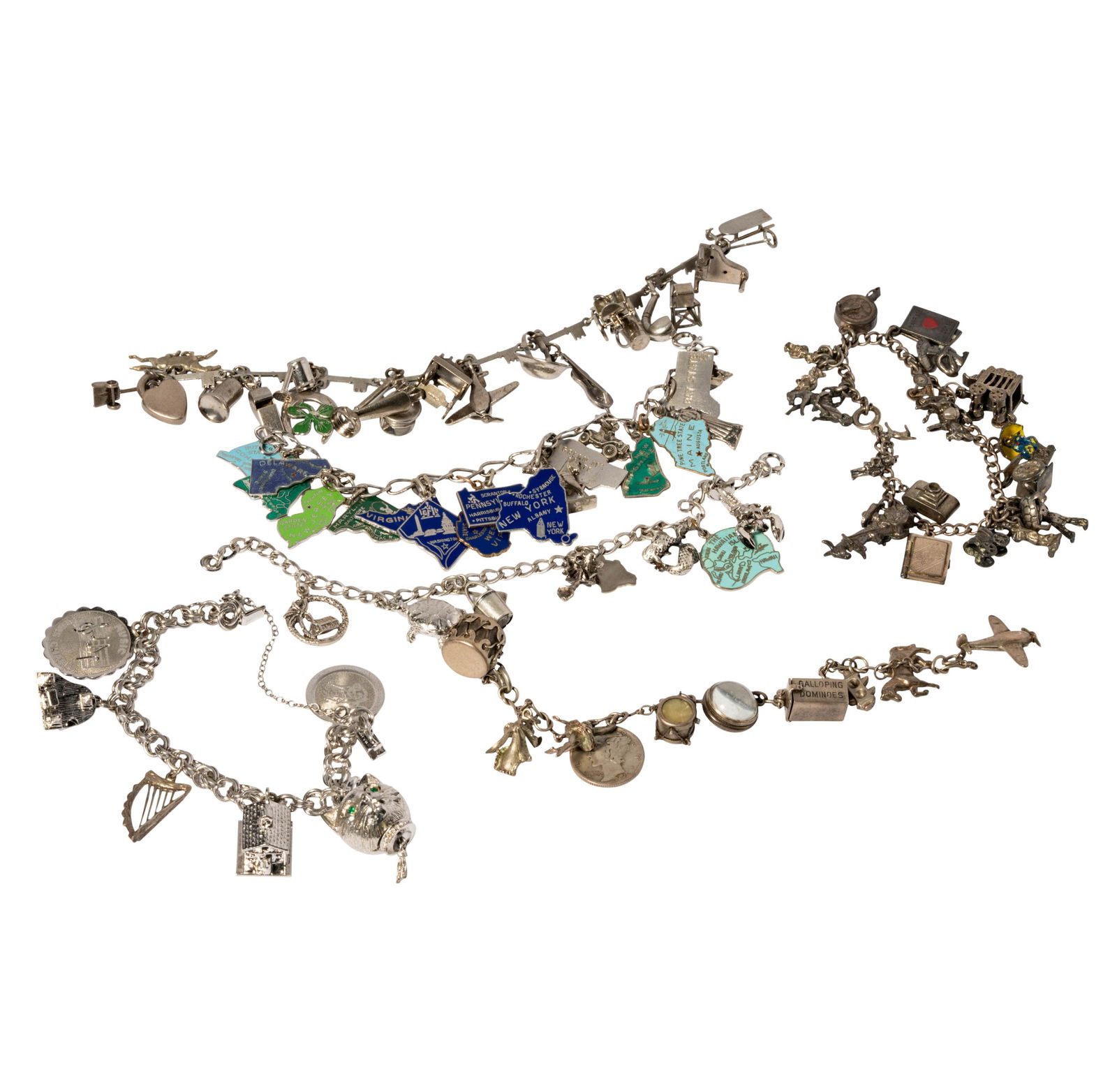 Group Of Six Silver and Silver-Tone Charm Bracelets: Including six bracelets with attached charms, each bracelet tested or hallmarked silver, some individual charms including sterling hallmarks, but not all tested; smallest bracelet measuring 6-1/8 inch