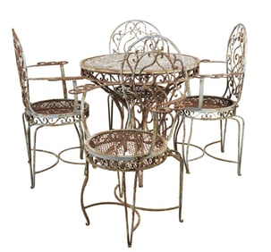 An Iron Tile-Top Patio Table with Four Chairs