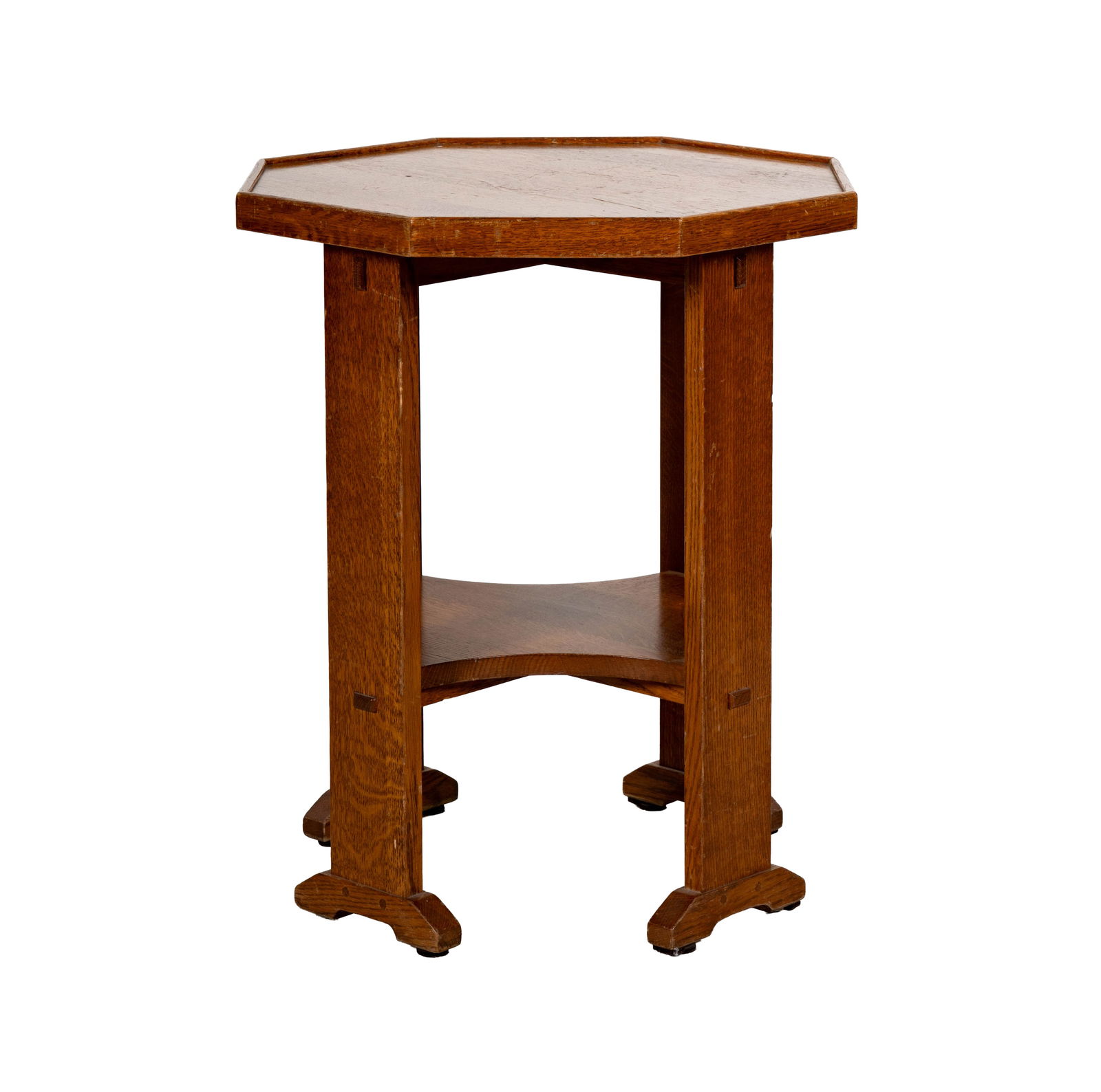 A Stickley Octagonal Oak Lamp Table: late 20th century; with label 24 1/2 x 20 in. (62.2 x 50.8 cm.)