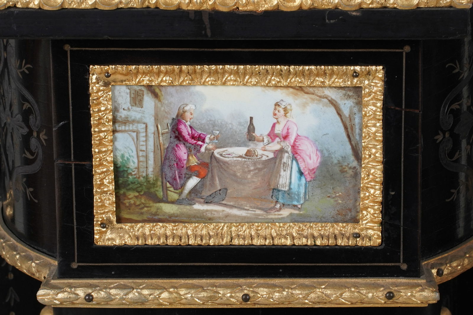 An Ebonized, GIlt Metal and Porcelain Pedestal: second half 20th century; with marble top and incised designs 46 1/2 x 16 x 12 1/4 in. (118.1 x 40.6 x 31.1 cm.)