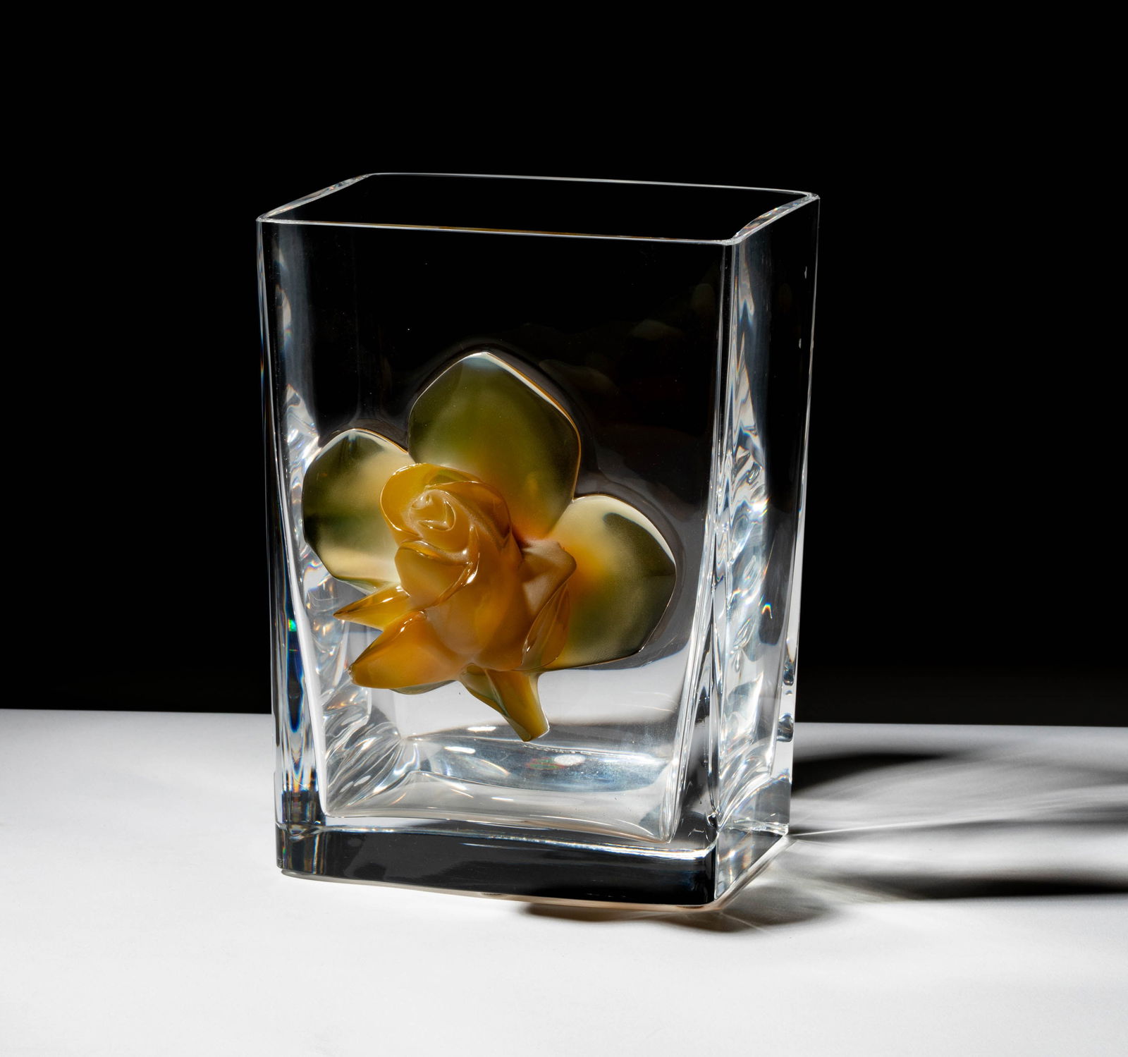 A Lalique Amber Rose Glass Vase: signed "Lalique France" 8 1/2 x 6 1/4 x 5 1/4 in. (21.6 x 15.9 x 13.3 cm.)