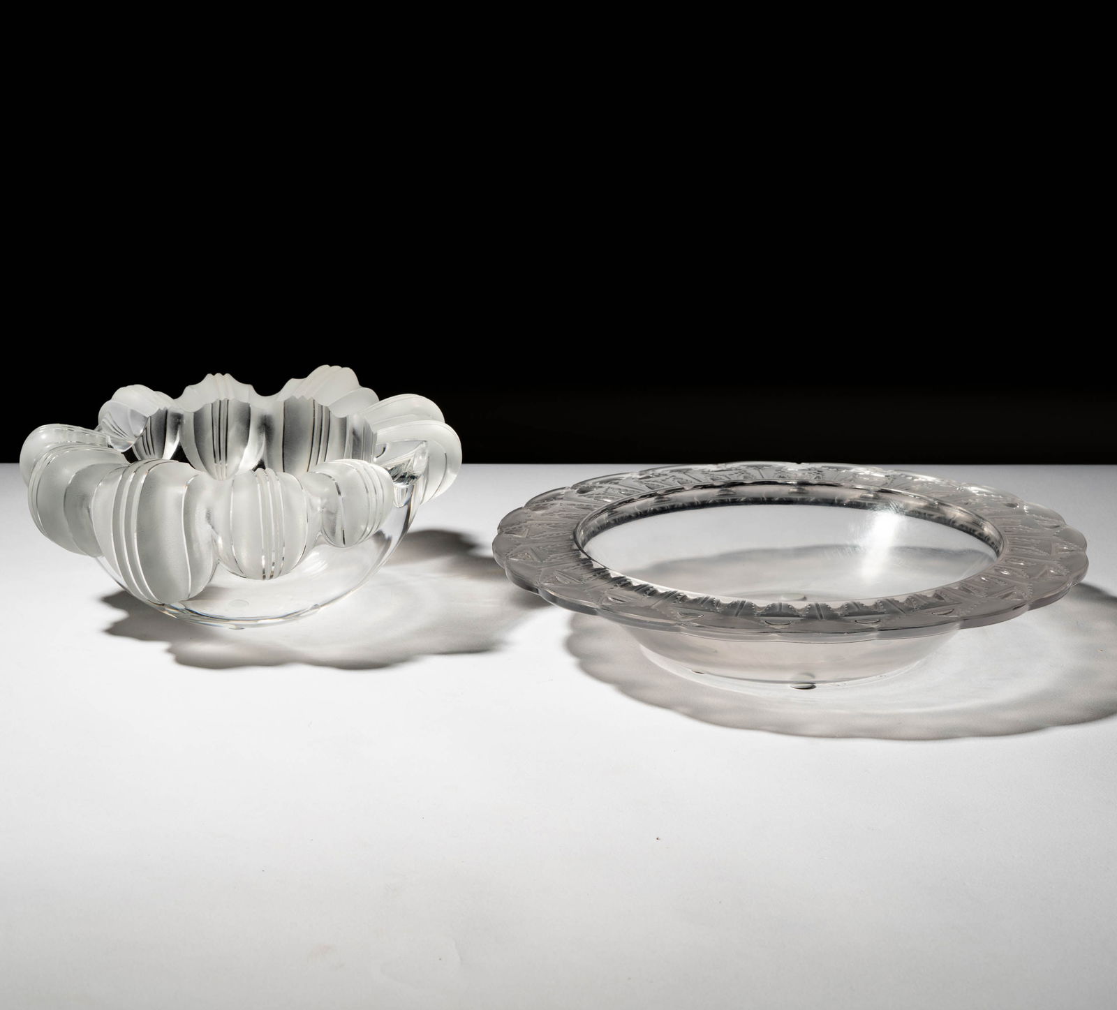 Two Lalique Glass Bowls: each signed "Lalique France" 2 x 10 1/2 in. (5.1 x 26.7 cm.) and 3 1/2 x 8 3/4 x 7 in. (8.9 x 22.2 x 17.8 cm.)