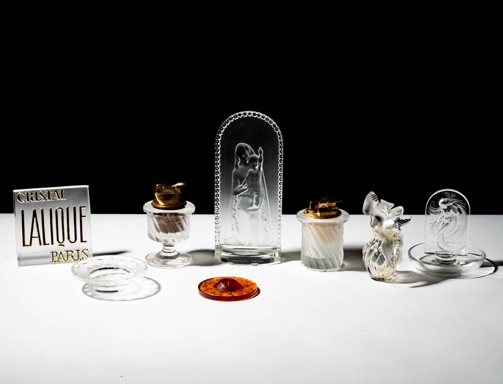 A Group of Eight Lalique Glass Table Articles: each signed "Lalique France" Tallest: 7 3/4 x 3 1/2 x 2 in. (19.7 x 8.9 x 5.1 cm.)