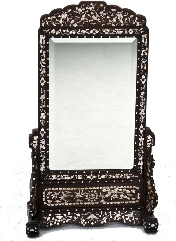 CHINESE HARDWOOD & MOTHER OF PEARL SHAVING MIRROR: the rectangular frame supported by a foliate inlaid stand 18 1/2 inches wide; 34 inches high
