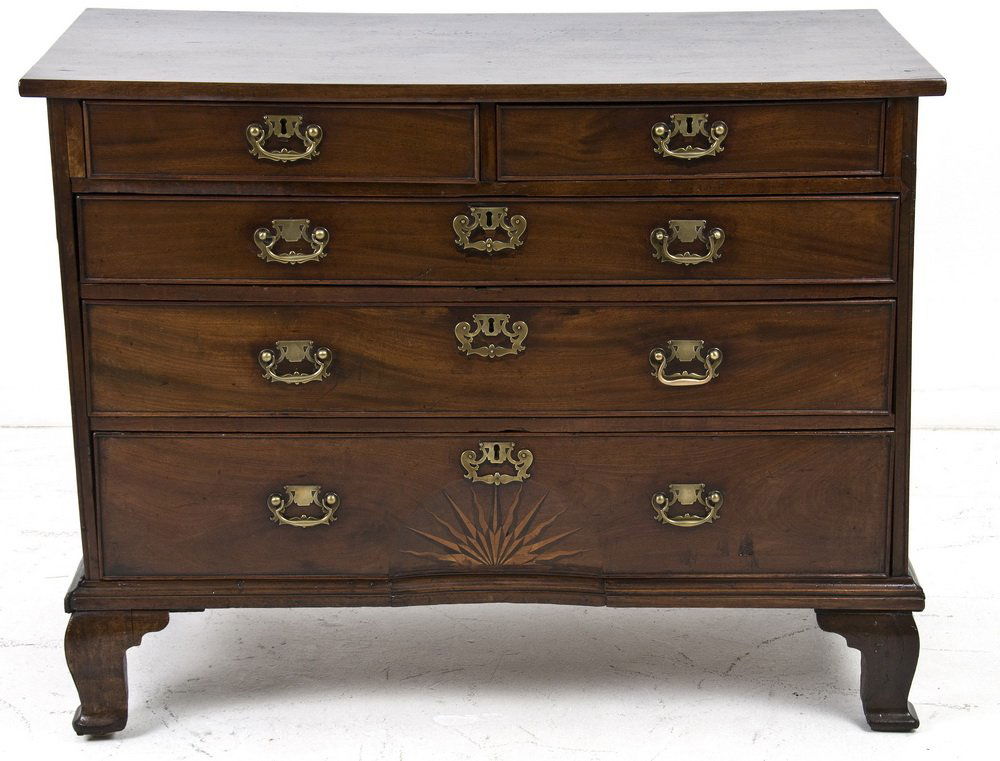 GEORGIAN MAHOGANY CHEST OF DRAWERS: the rectangular top above two short and three long drawers, the bottom drawer with a rising sun inlay 43 inches wide; 23 inches deep; 33 inches high
