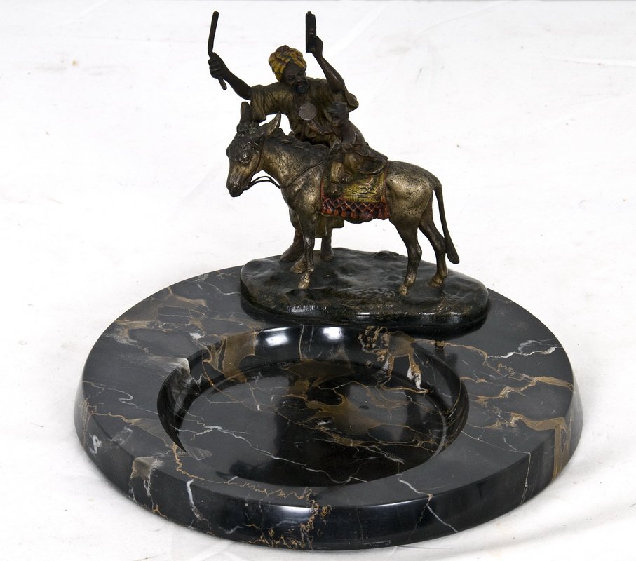 VIENNA COLD-PAINTED BRONZE FIGURAL GROUP: depicting a Tunisian musician with tambourine and mallet standing next to a donkey with a monkey playing tambourine on its back, now mounted on a variegated marble ashtray pan, stamped Austria Provena