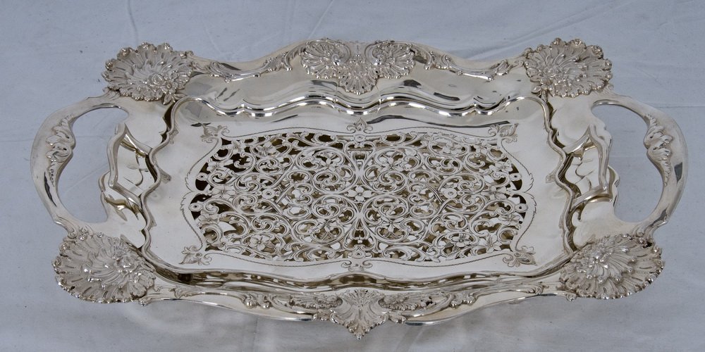 TIFFANY & CO. STERLING ASPARAGUS TRAY: in two parts, having a removable rectangular footed liner, sitting in a conforming base with foliate and shell cast edge, raised on four feet 48 troy ounces Provenance: Estate of David Copley, La Joll