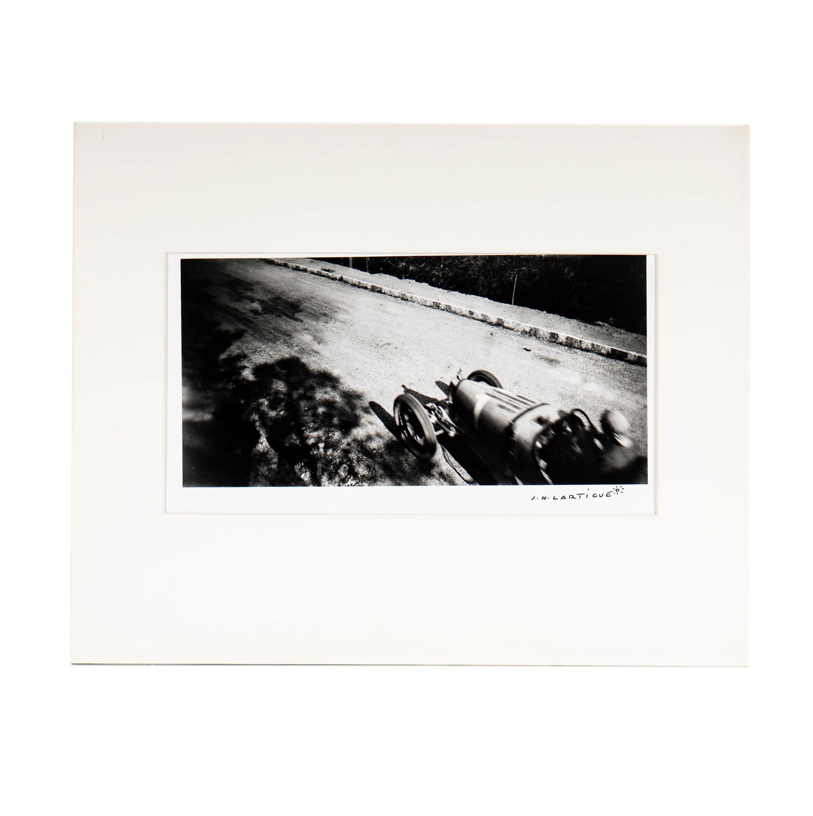 Jacques Henri Lartigue: Vintage Bugatti Photograph: signed in marker lower right, embossed signature lower left, unframed, taped to paper mat folder, Image size: 6.75 x 13.5 in., Total size: 16 x 20 inches