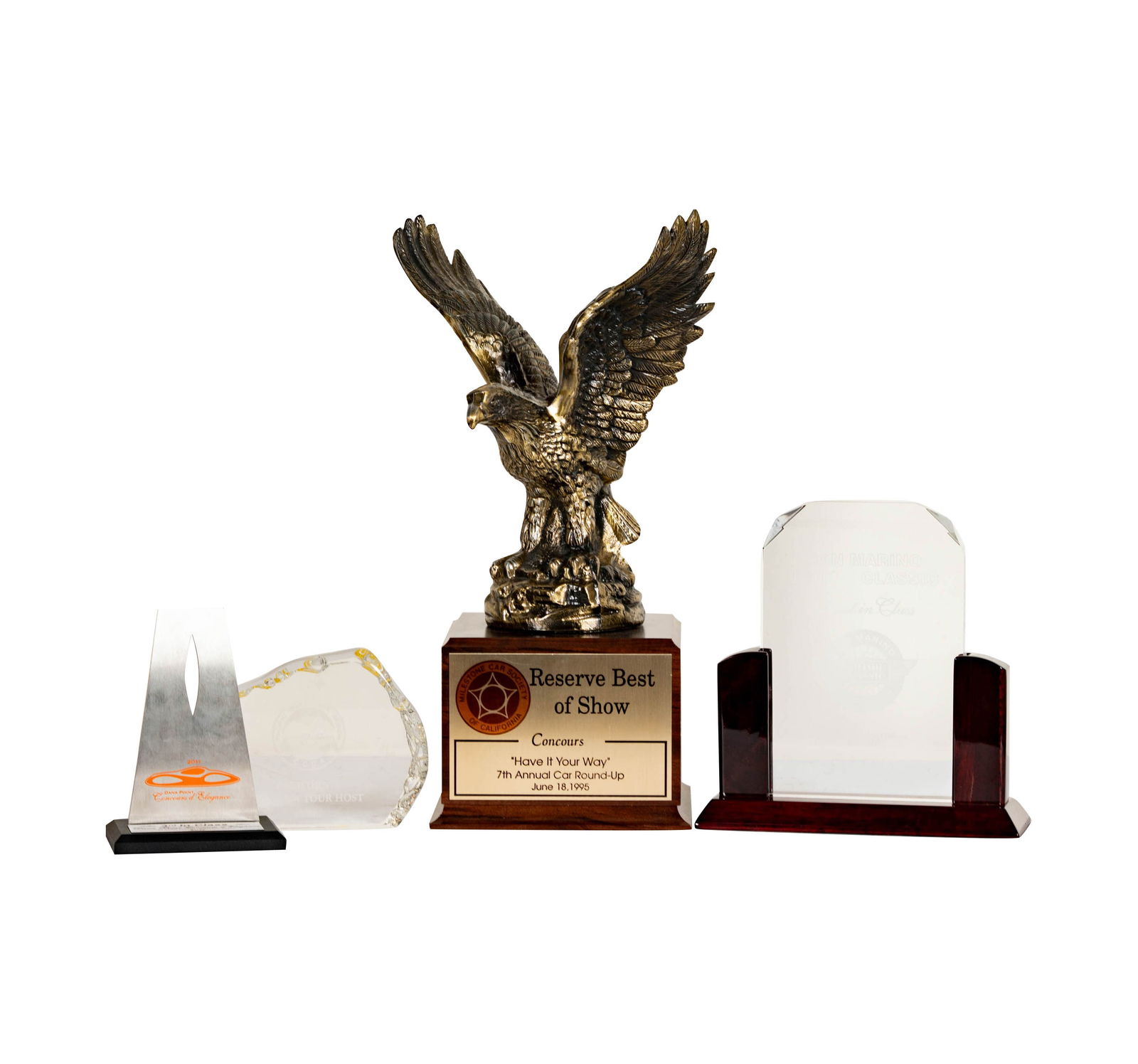 Four California Car Trophies: including the glass sculpture for the Pacific Northwest Region CCCA California Museum Tour Host 2006, the San Marino Motor Classic First in Class 2013 Award, and the eagle form metal and wood trophy f