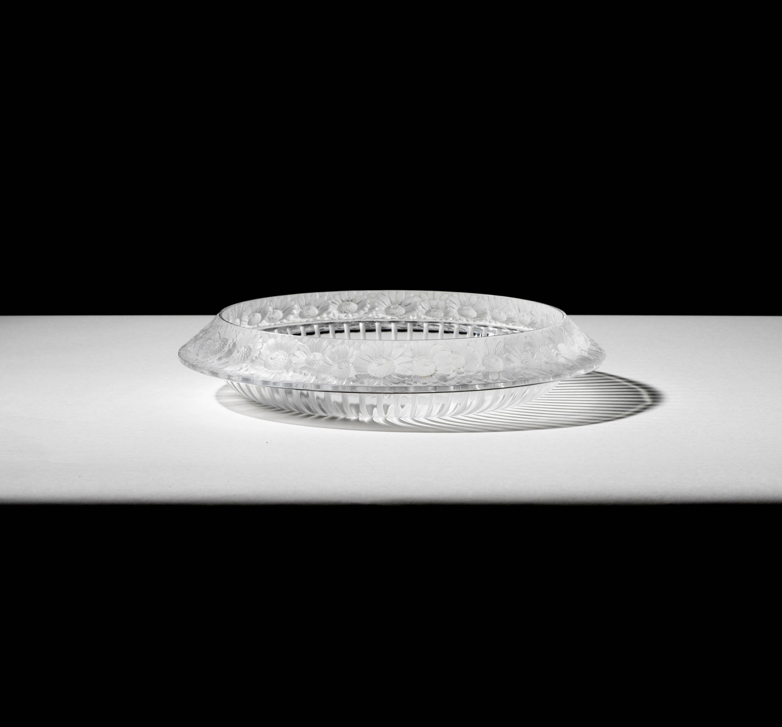 A Lalique Marguerites Molded Glass Center Bowl: signed "Lalique France", 2 1/2 x 13 1/4 in. (6.4 x 33.7 cm.)