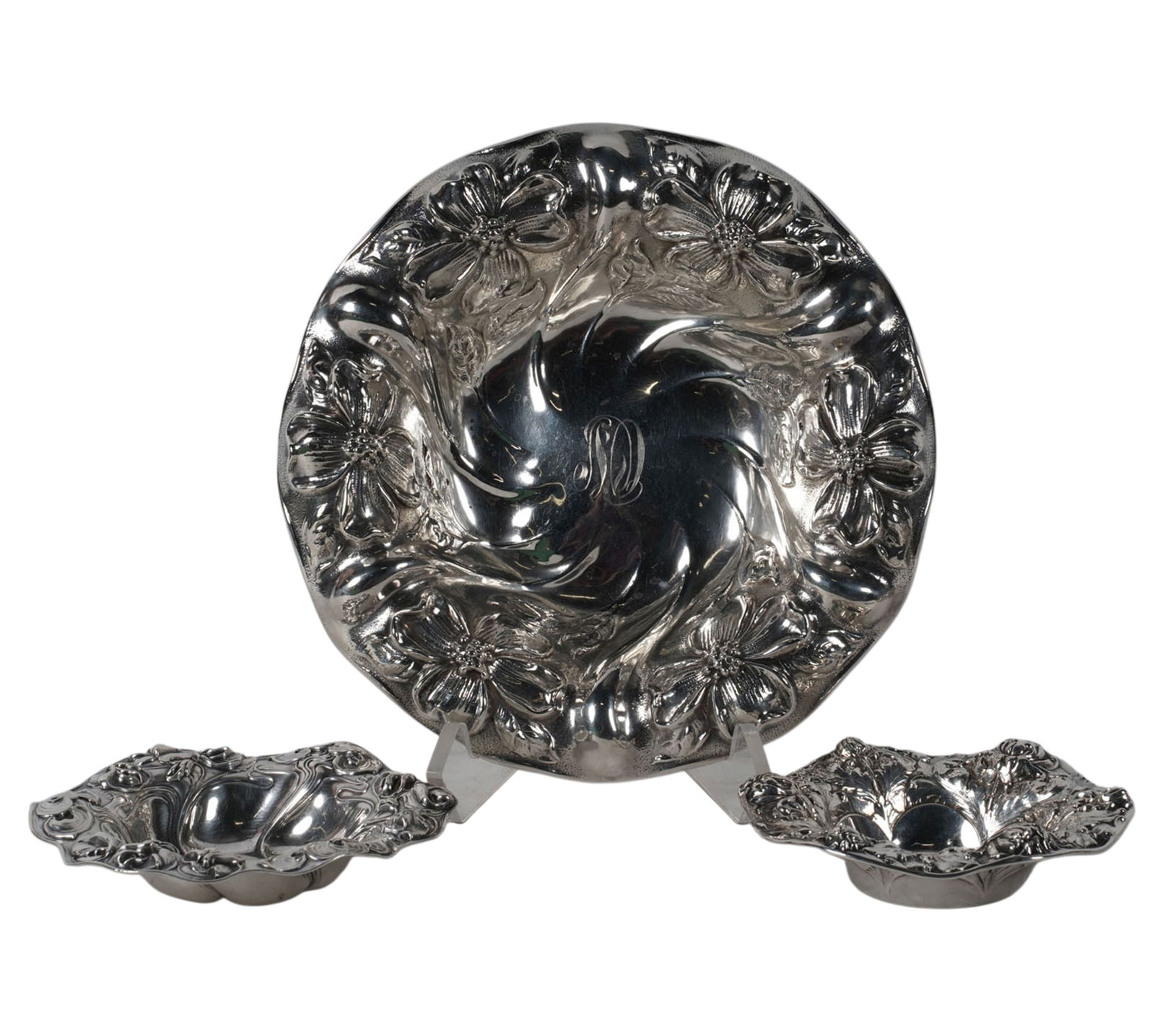 Three American Sterling Repousse Bowls: each with floral motif to rim, the first: Mauser Manufacturing Co., New York, NY, monogrammed to center, Approximately 294 grams, 2 1/4 x 10 in., the second: Gorham, Providence,