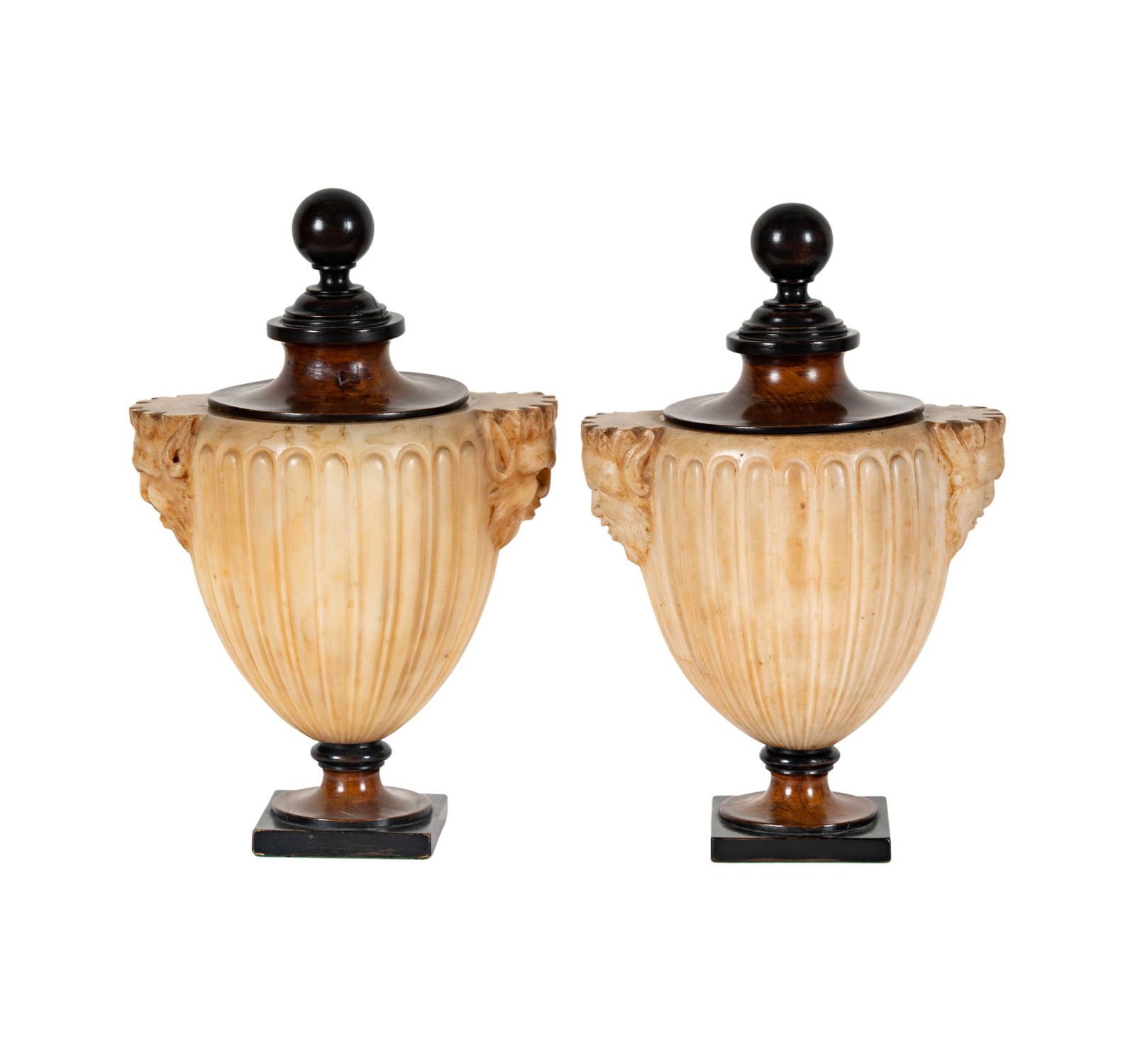 A Pair of Regency Grand Tour Carved Alabaster Urns: c. 1820s, each with wooden ball finial over a fluted body flanked by mask-form handles, on pedestal base, 13 1/2 x 8 1/2 x 7 in.