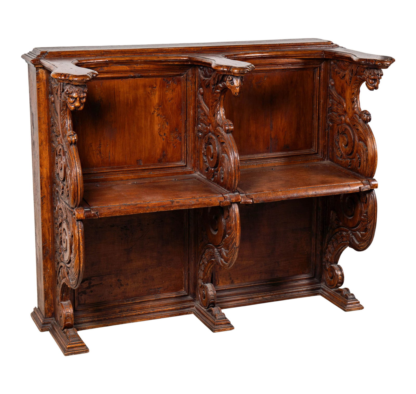 An Italian Baroque Carved Walnut Choir Stall: 17th century, with two hinged seats divided by foliate-scroll supports with animal's heads, 53 x 42 x 24 1/2 in.