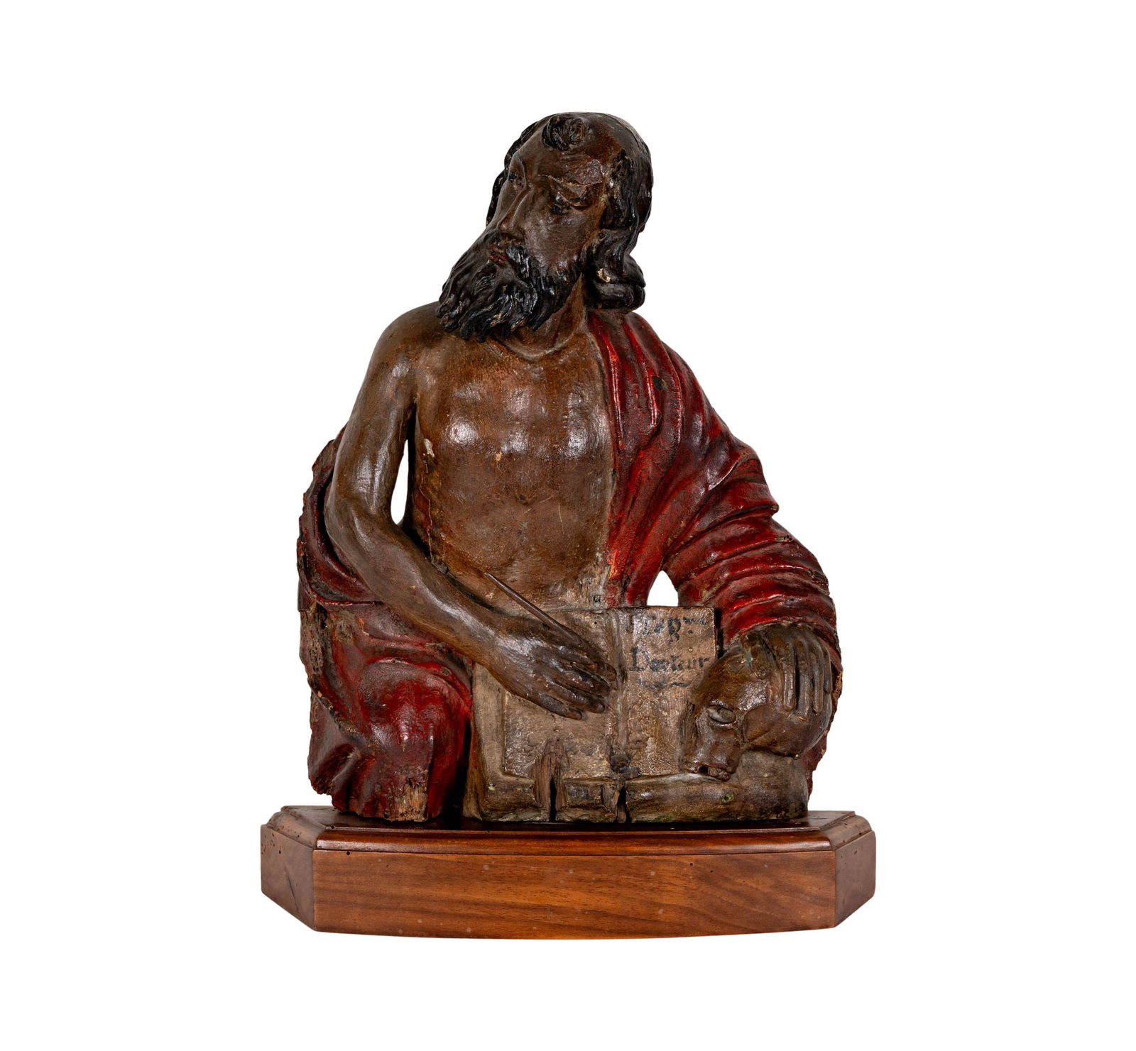 A Carved and Painted Wood Figure of a Saint: 17th/18th century, the half-length figure depicted writing in a book, mounted to a stained wood plinth, 15 in. high, overall: 17 x 13 1/4 x 3 in.