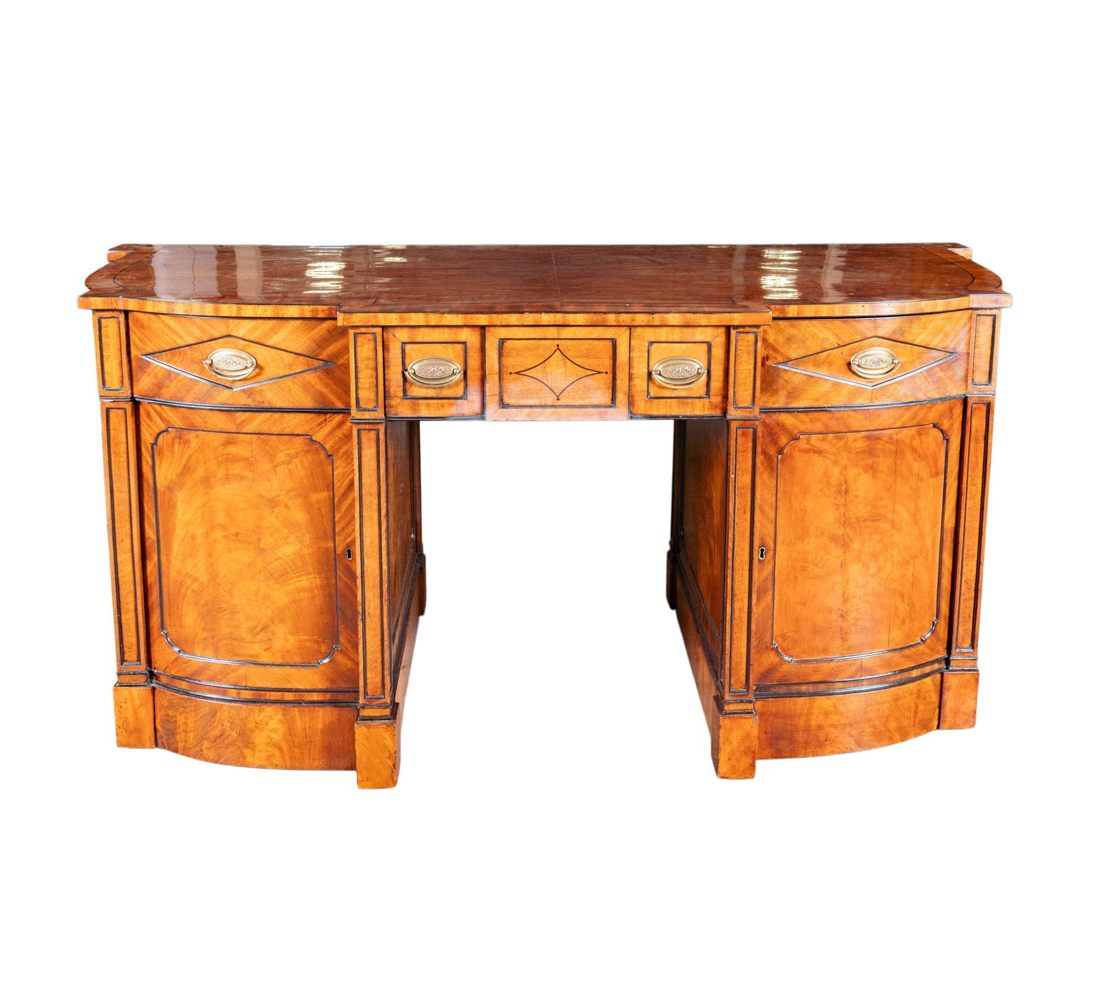 A Walnut Sideboard: in three parts 36 1/2 x 67 1/2 x 30 in. (92.7 x 171.5 x 76.2 cm.),