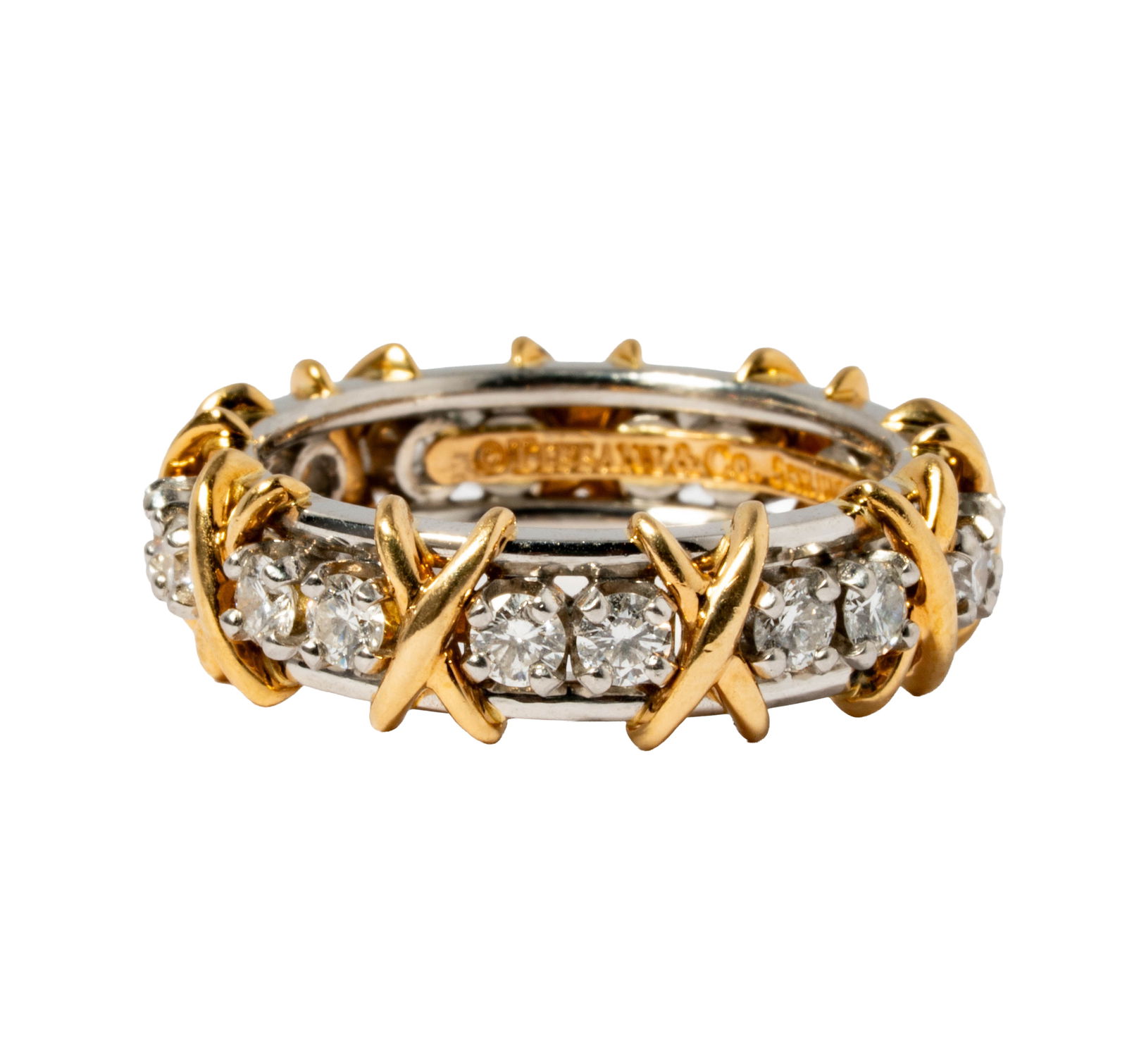 Schlumburger, Tiffany & Co., Platinum and 18 Karat Yellow Gold Diamond Band: set with 18 small round full-cut diamonds [F-G/VVS2] weighing approximately 1.40 carats total; size: 8-1/2, weighing 11.1 grams;