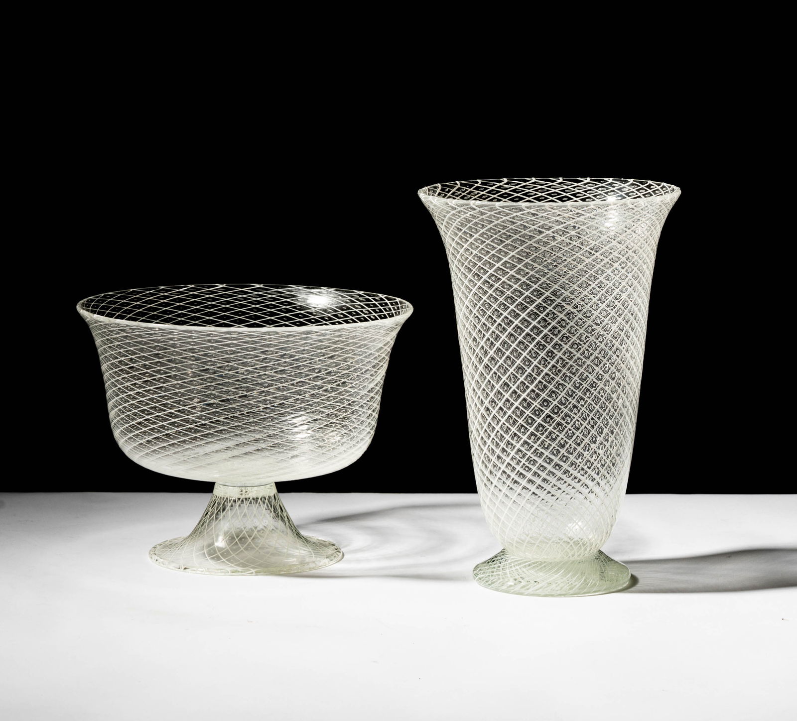 An Anfora Murano Reticello Glass Vase and Bowl: each clear with white lattice and controlled bubbles, each signed Anfora Murano, bowl: 6 1/2 x 8 1/2 in.,vase: 10 in. high