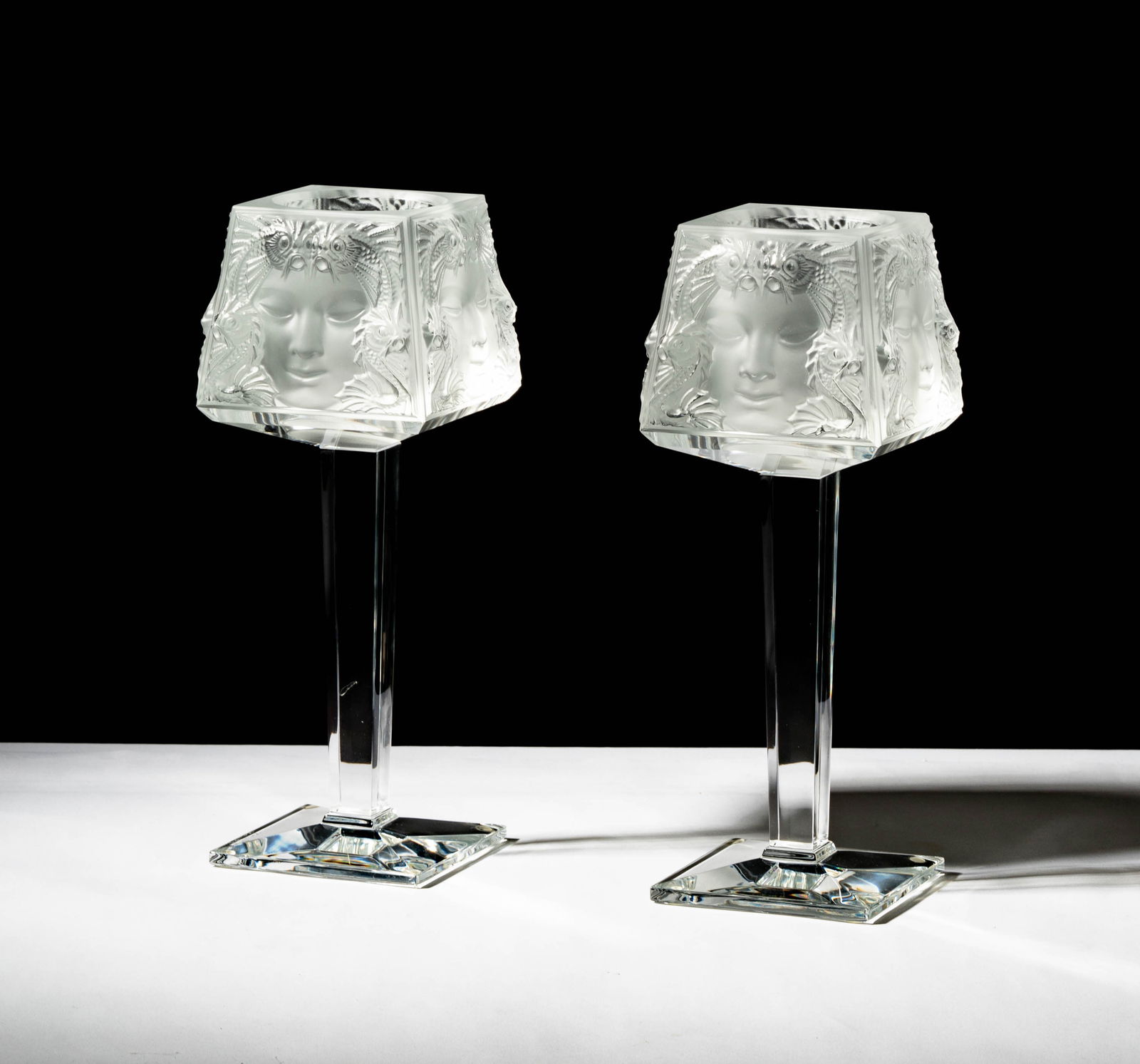 A Pair of Lalique Masque De Femme Footed Votives: signed Lalique France, 12 x 4 1/2 x 4 1/2 in. (30.5 x 11.4 x 11.4 cm.)