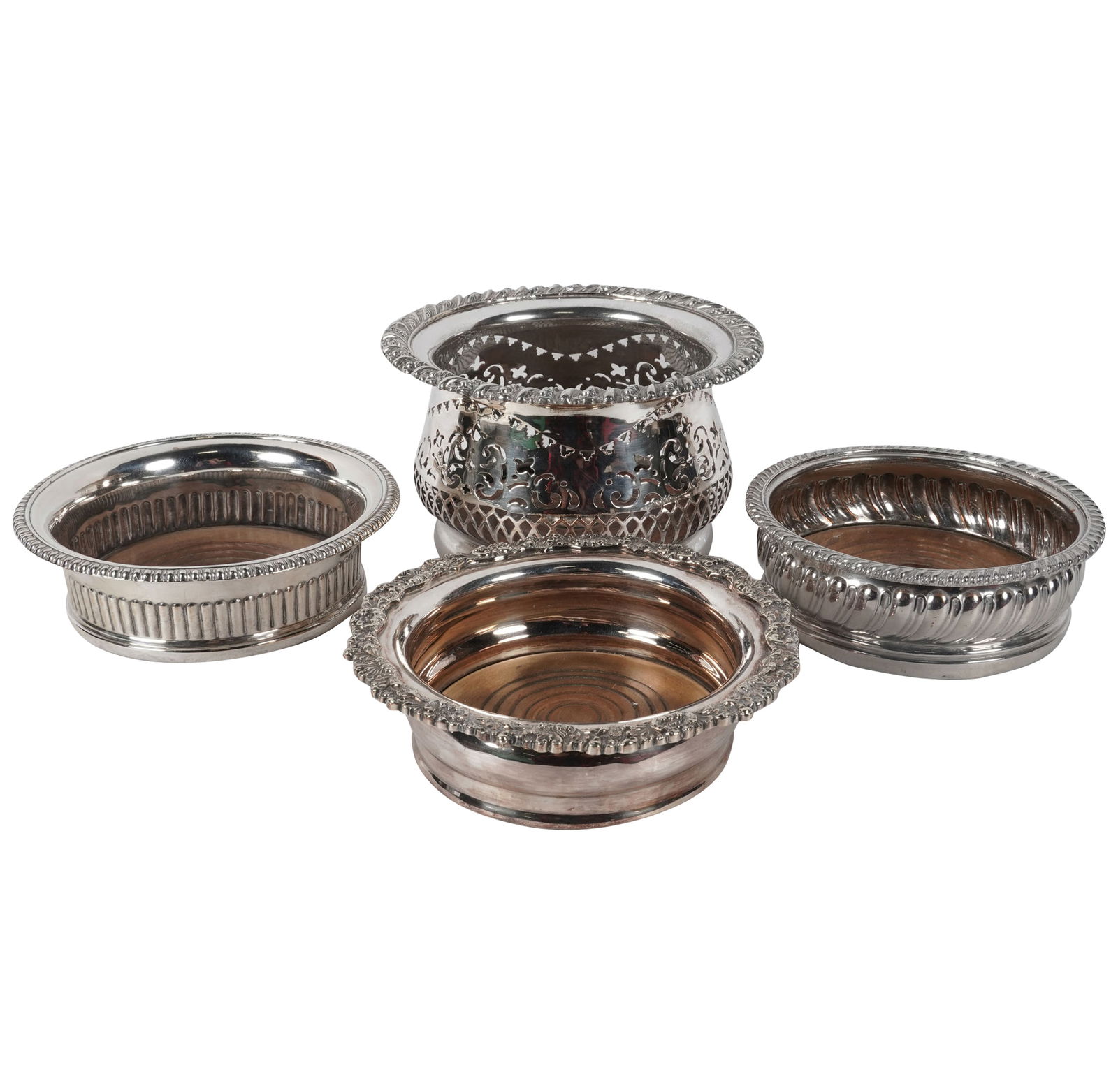 Four Silver Plate Wine Bottle Coasters: each wood lined bottoms, the largest: 4 1/4 x 6 3/4 in.