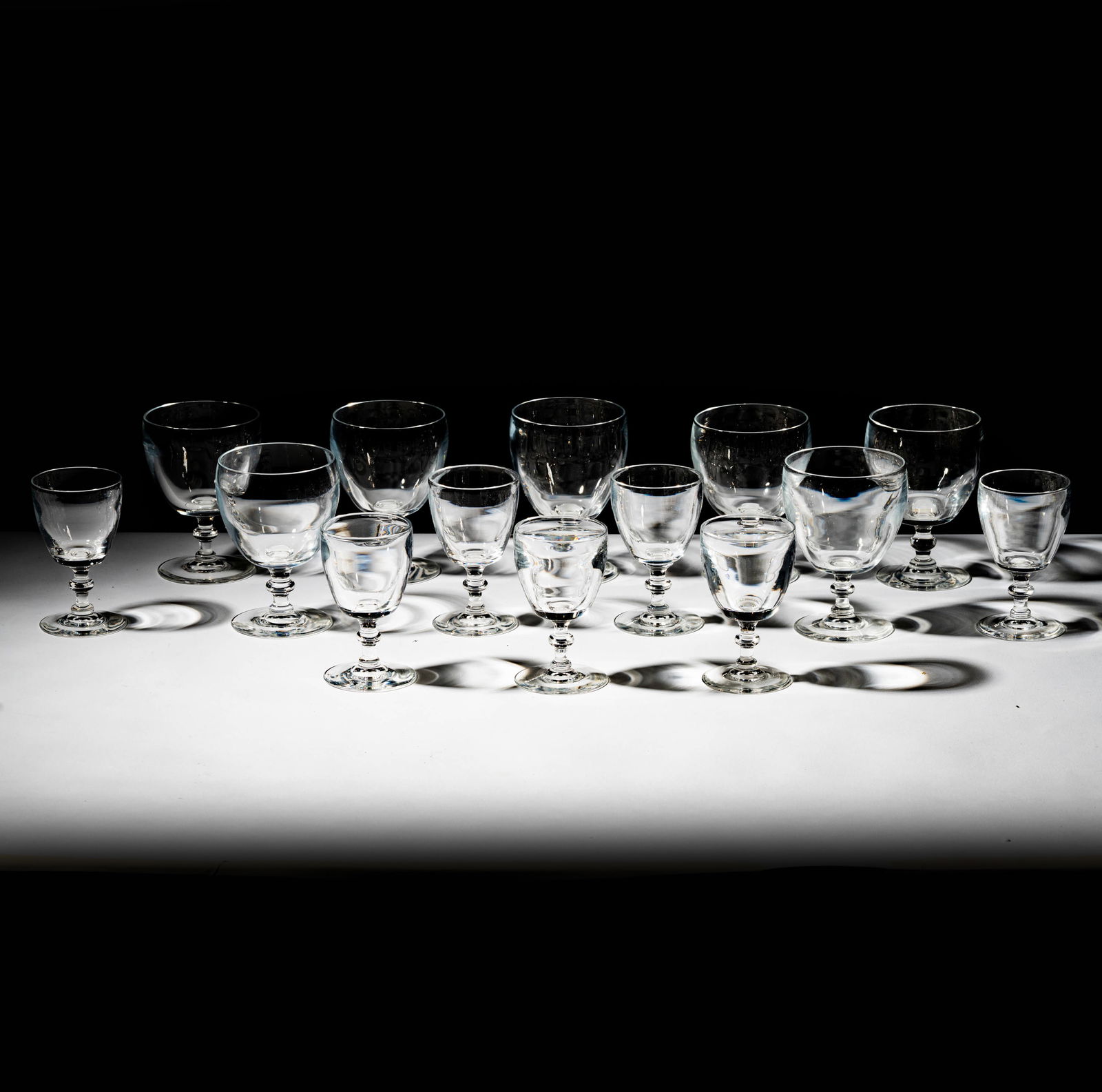 Steuben Glass Drink Set: comprising seven larger glasses (5 1/8 x 3 3/4 in.) and seven smaller glasses (4 5/8 x 2 3/4 in.), each signed to underside (14 pieces total)