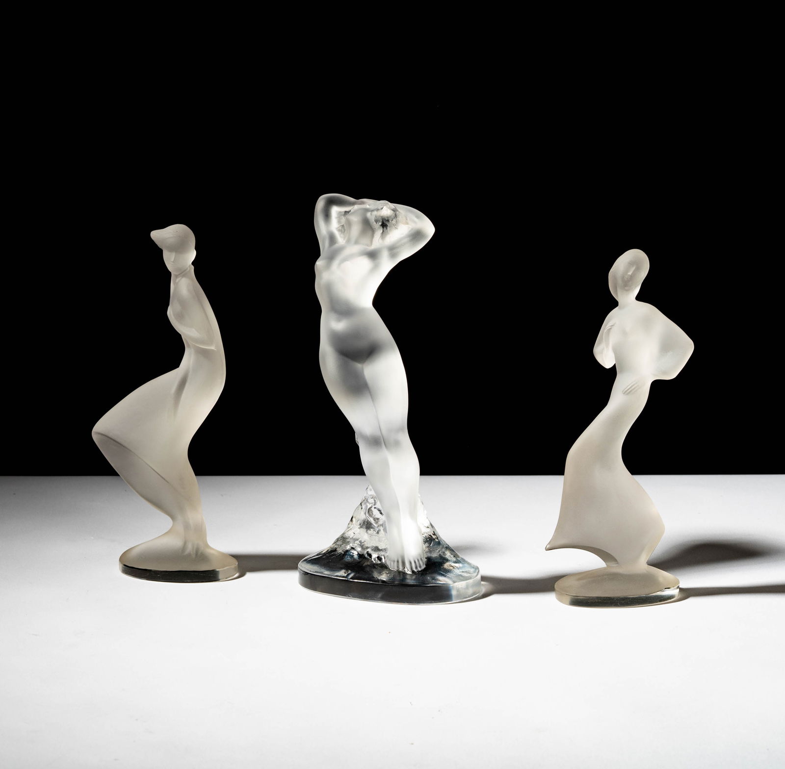 Three Lalique Figures: each marked, the nude: 9 in. high, the other: 8 1/2 in. high