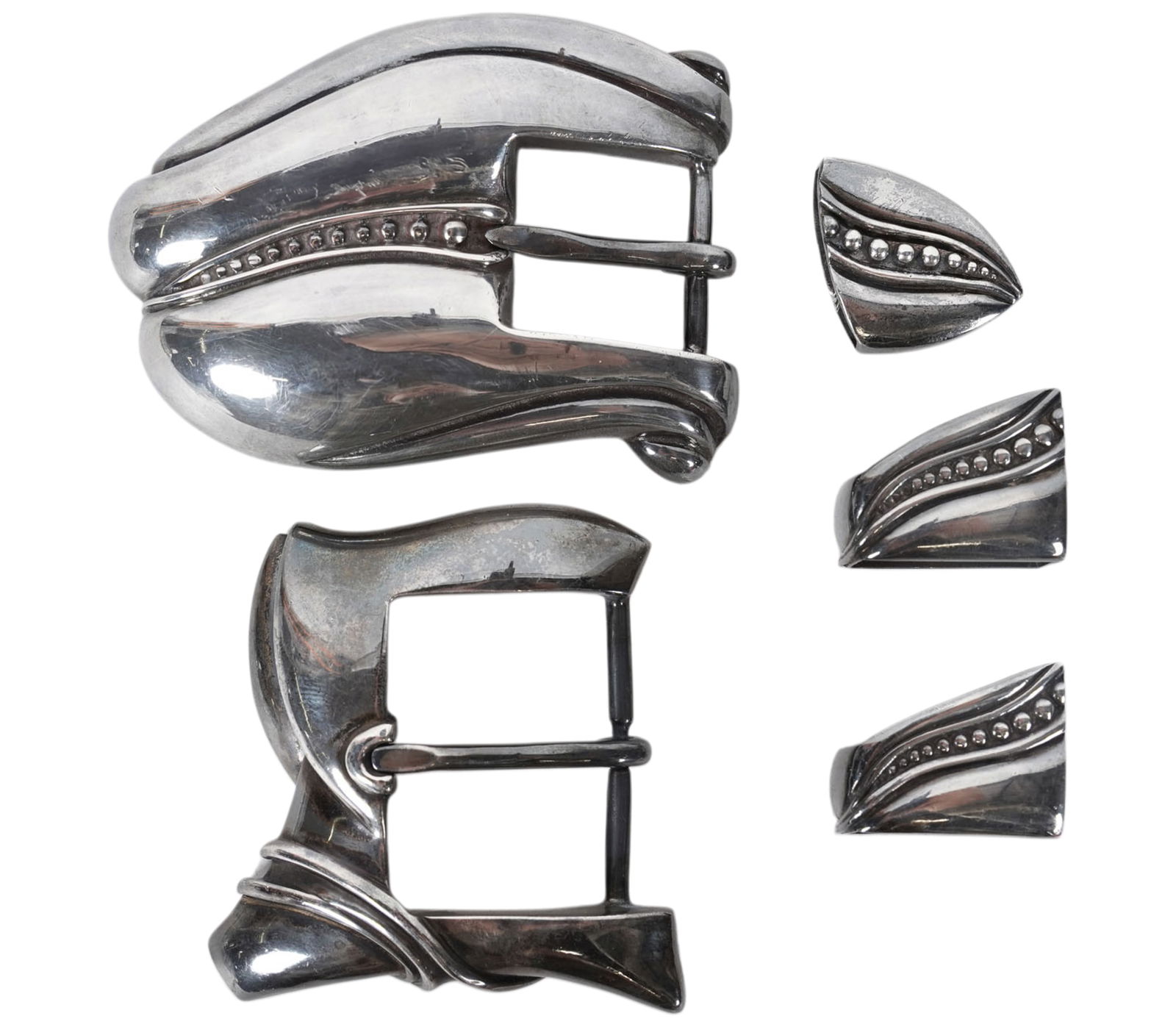 Two Kieselstein-Cord Belt Buckles: each with maker's mark, the first: marked "Sterling", "891" and dated 1981 (2 1/4 x 3 in.) with three mounts (approximately 120 grams total); the second: stamped "BB05" and dated 1986 (2 1/2 x 2 1/2