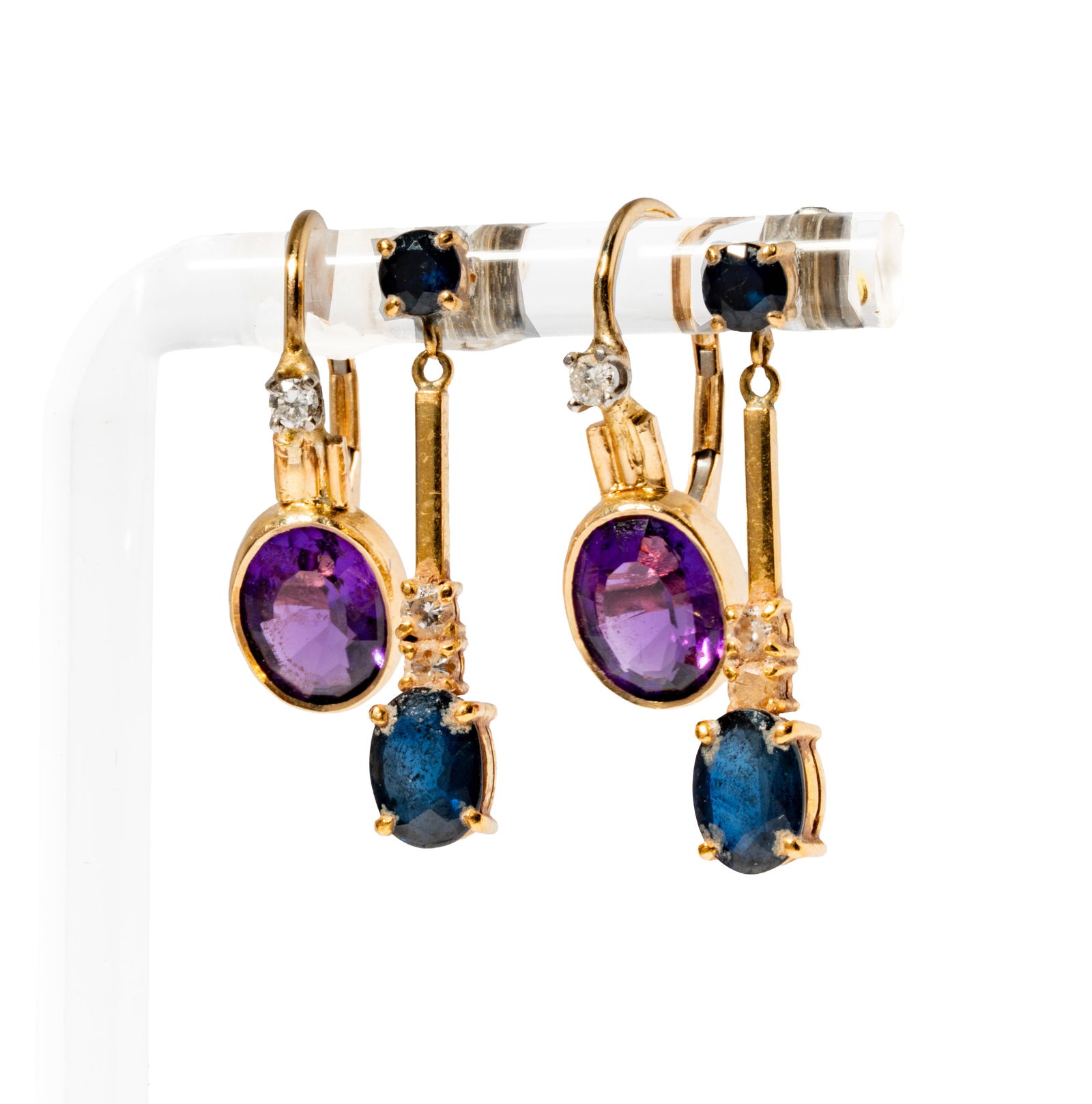 Two Pairs of Gold, Gem-set, & Diamond Earrings: Including one pair of amethyst and diamond earrings set with two oval-cut amethysts weighing approximately 2.40 carats, and with two small round diamonds weighing approximately .05 carats; one pair