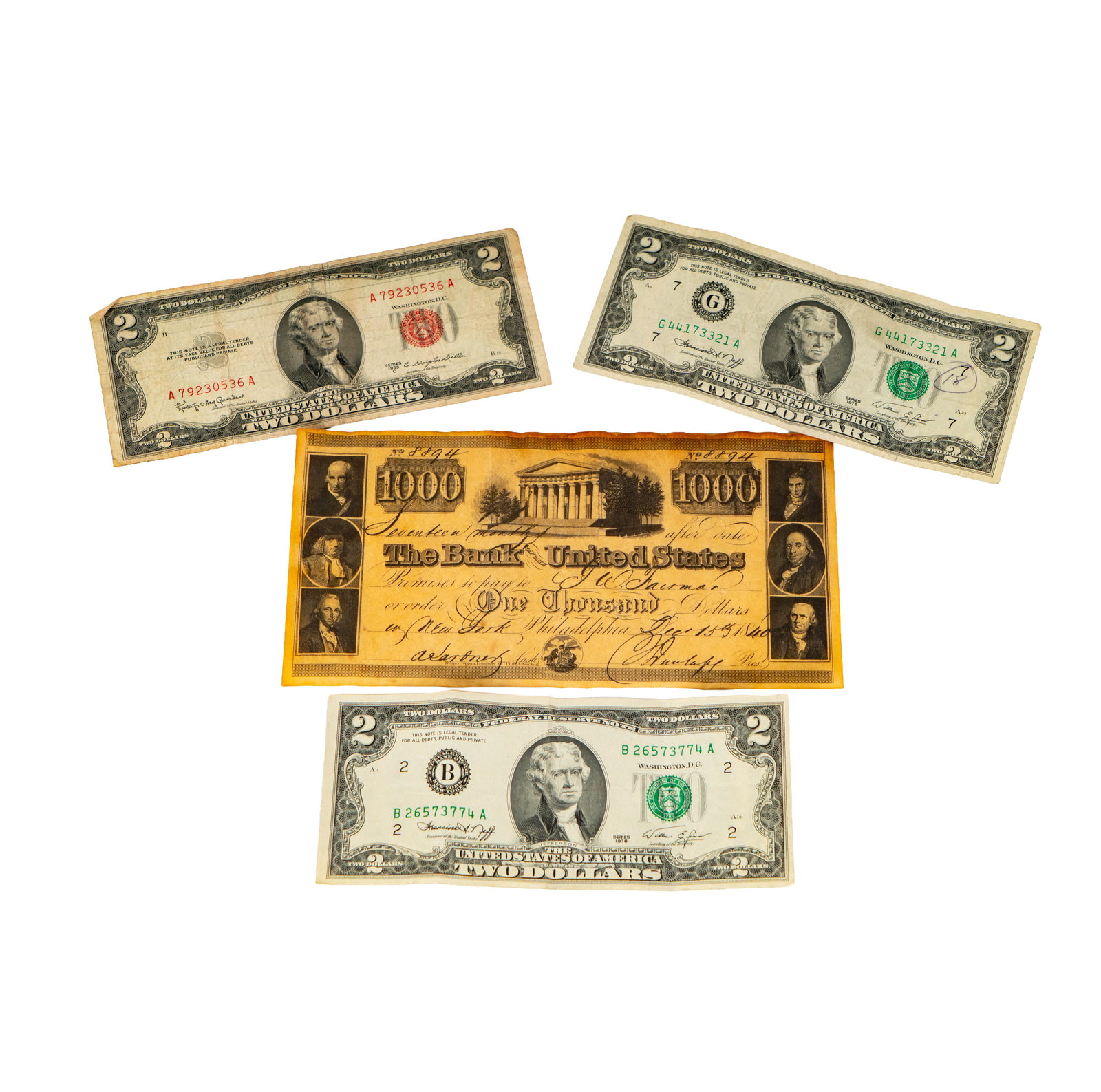 Group of Two dollar bills and one 1000 dollar bill: Including one 2$ dollar red serial bill, one 1000$ bill and several 2$ bills;