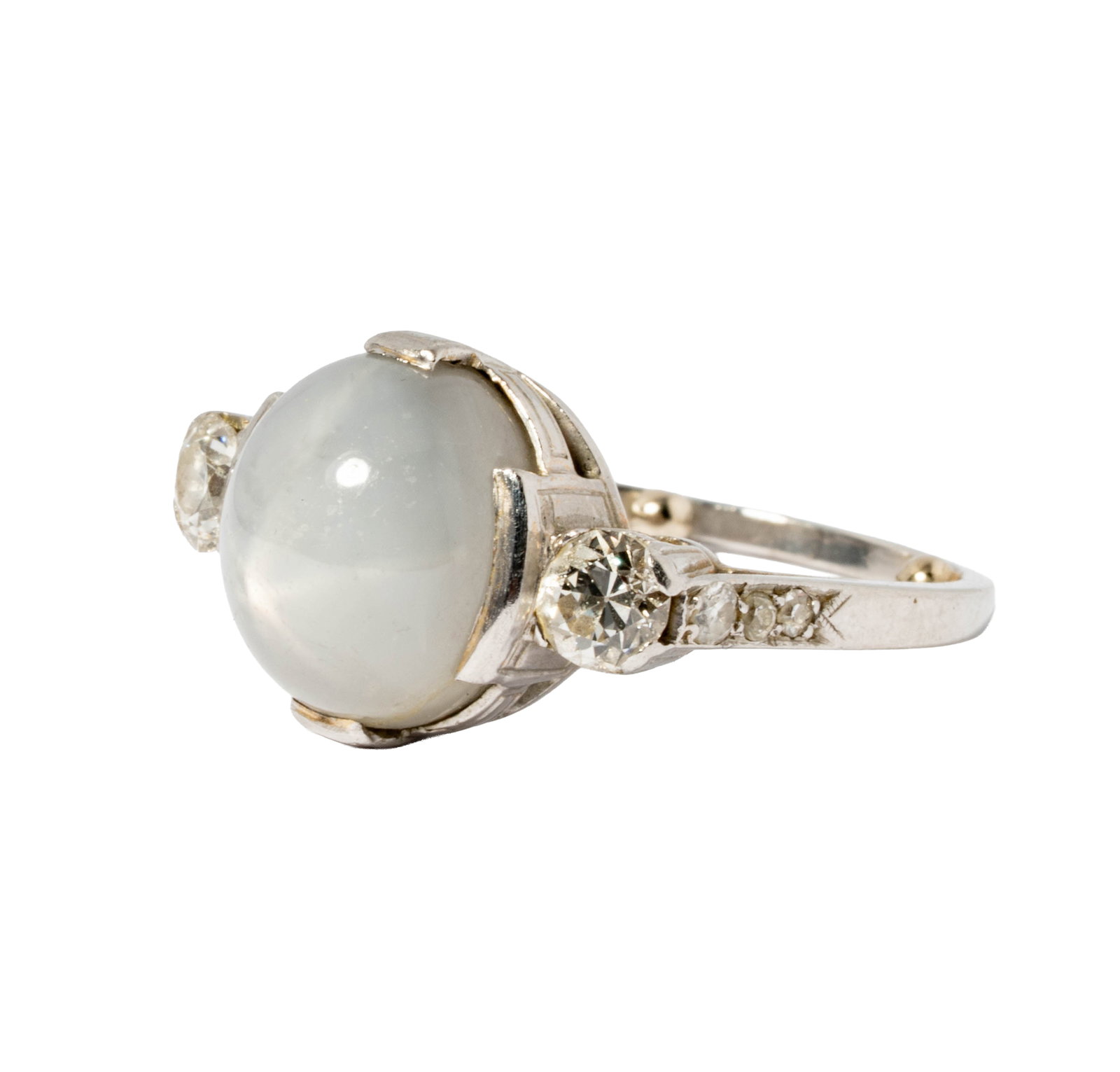 Platinum, Star Sapphire and Diamond Ring: set with one large cabochon star sapphire weighing approximately 11.90 carats, and accented with eight small mixed-cut diamonds [G-I/I-3] weighing 0.55 carats; ring size: 7-1/2, weighing 8 grams;