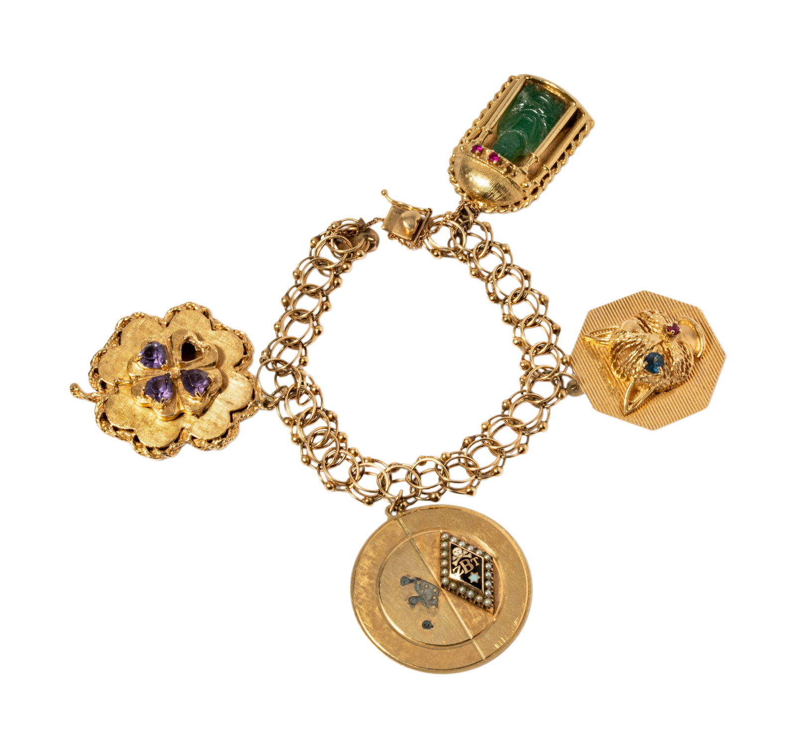 14kt yellow gold vintage double link charm bracelet: Including one 14 karat yellow gold charm bracelet set with four large charms, largest charm measuring 1-3/4 inches tall (amethyst set clover charm); bracelet measuing 6-3/4 inches long by 1/4 inches w