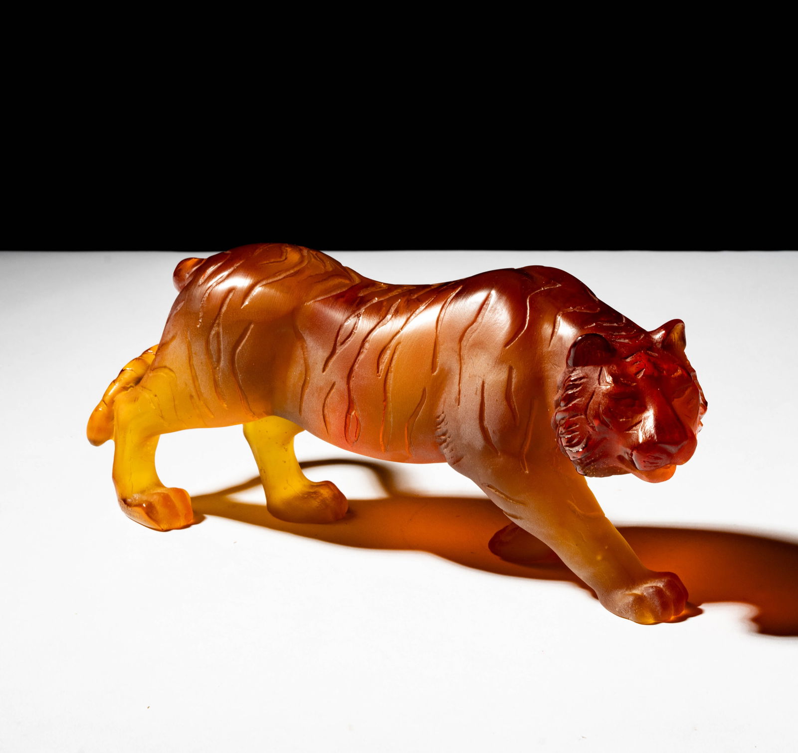 Daum Pate de Verre Tiger Figure: amber-colored, signed 'Daum France", 5 x 10 1/2 x 3 in.