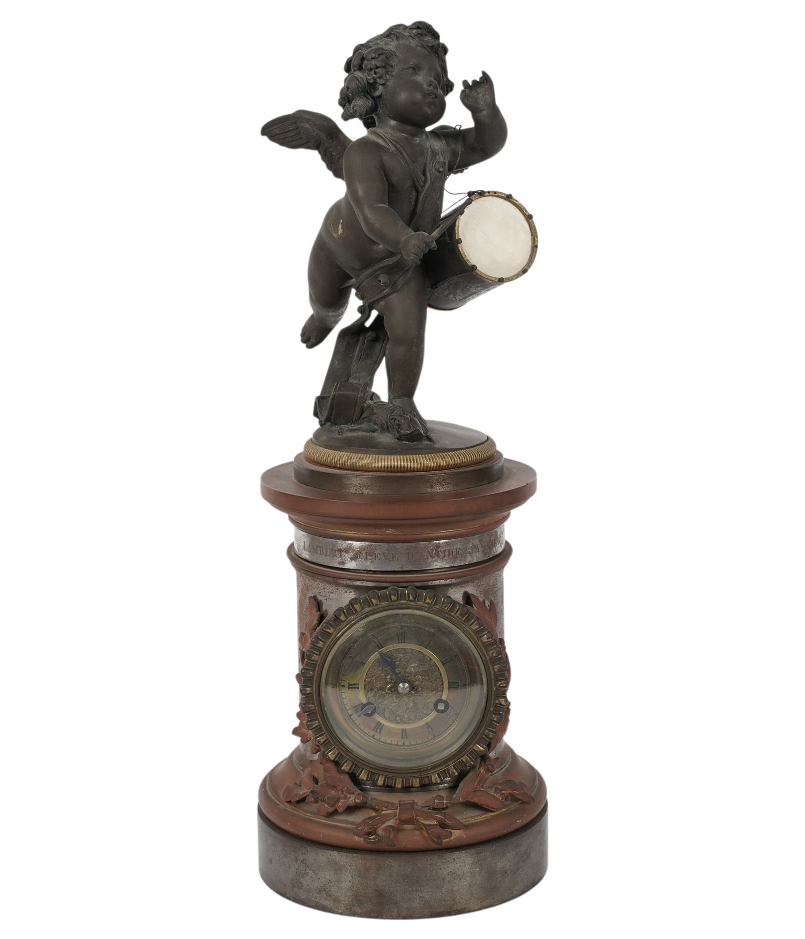 French Brass and Steel Figural Clock: surmounted by a patinated metal figure of a cherub, the case with engraved inscription to collar, the brass dial signed "[illegible] Paris", 16 1/2 x 5 3/4 in.