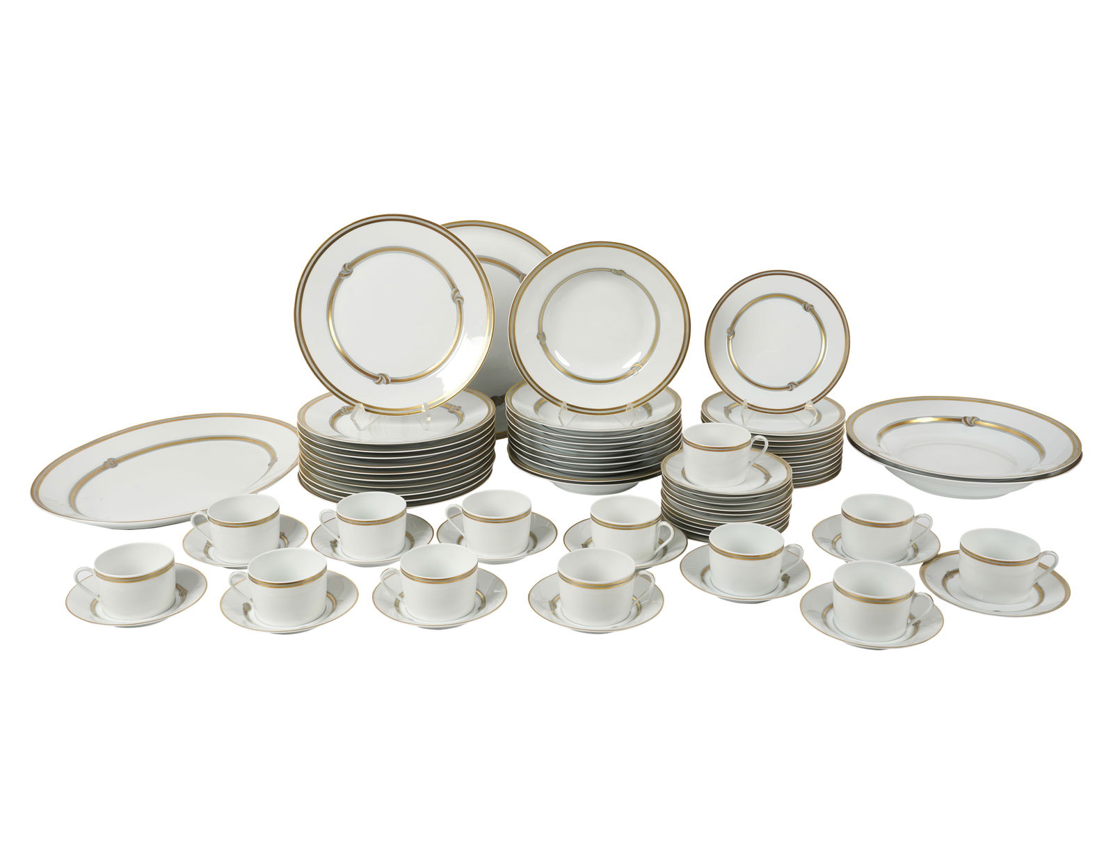 A Christofle Ruban Or Porcelain Service: A Christofle Ruban Or Porcelain Service comprising 11 dinner plates (10 1/4 in. dia.), ten soup plates (9 1/4 in. dia.), 12 salad plates (7 3/4 in. dia.), 11 bread plates (6 1/4 in. dia.), 13 cups, 11