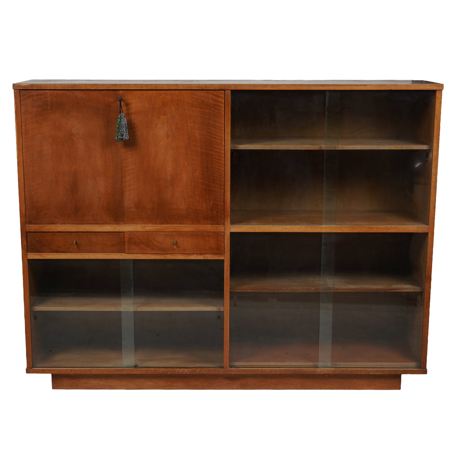 Scandinavian Mid-Century Modern Bookcase: walnut, glass, 51 x 67 x 14 in. (129.5 x 170.2 x 35.6 cm.) Provenance: The Los Angeles Estate of Otto and Gail Natzler, the personal residence of Otto and Gertrud Natzler Los Angeles