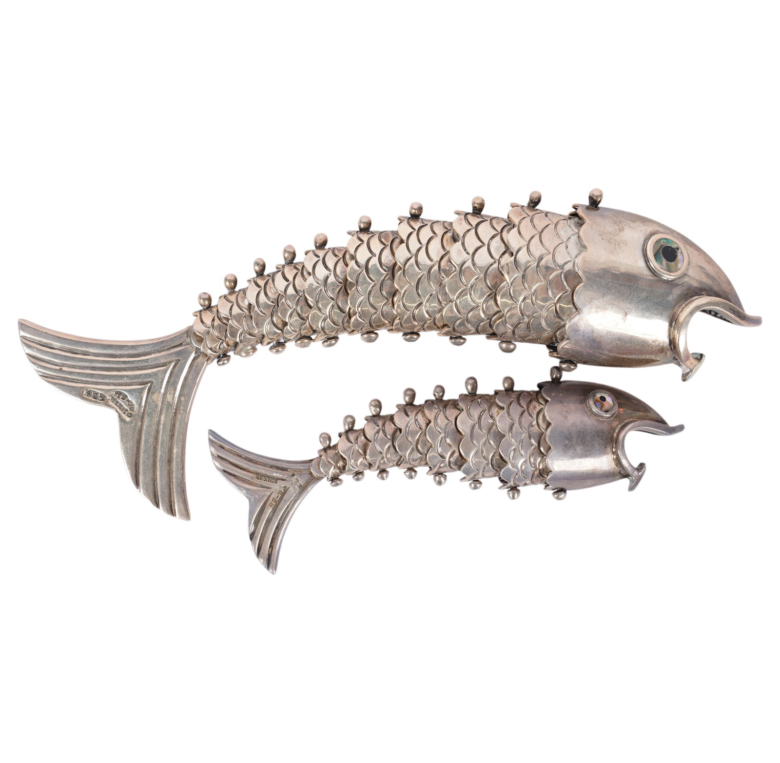 Two Mexican Sterling Fish-Form Bottle Openers: after 1980, each with articulated body and shell-inlaid eyes, each with registration number "TD-96", "925" and "Mexico", approximately 133 grams total gross, 4 1/4 in. wide and 6 1/4 in. wide