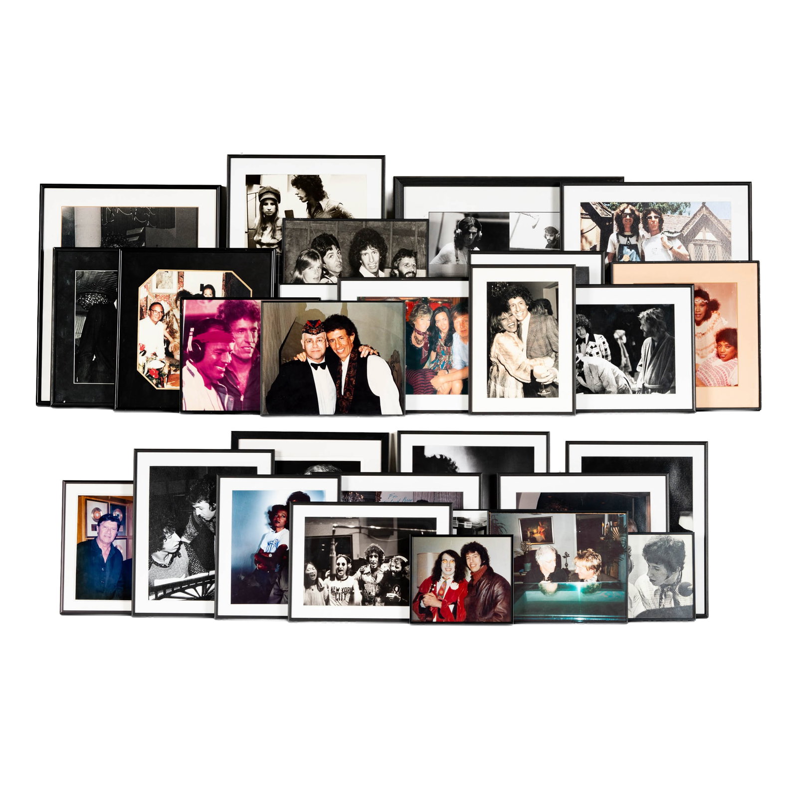 Collection of Richard Perry's Celebrity Photos: A collection of framed photographs featuring various celebrities, including musicians and actors, captured by photographer Richard Perry. The images showcase candid moments and posed portraits, offeri