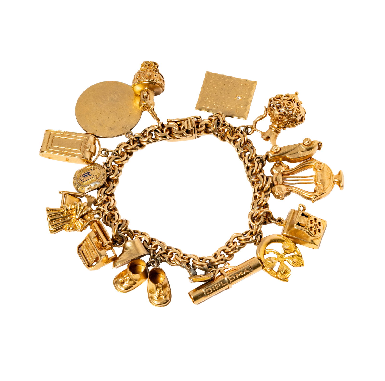 14 Karat Yellow Gold Charm Bracelet: Including one 14 karat yellow gold charm bracelet, largest charm measuring 1 inch tall, the smallest measuring 1/2 an inch; one gold filled fraternity charm; measuring 7-1/4 inches long, weighing 69.4