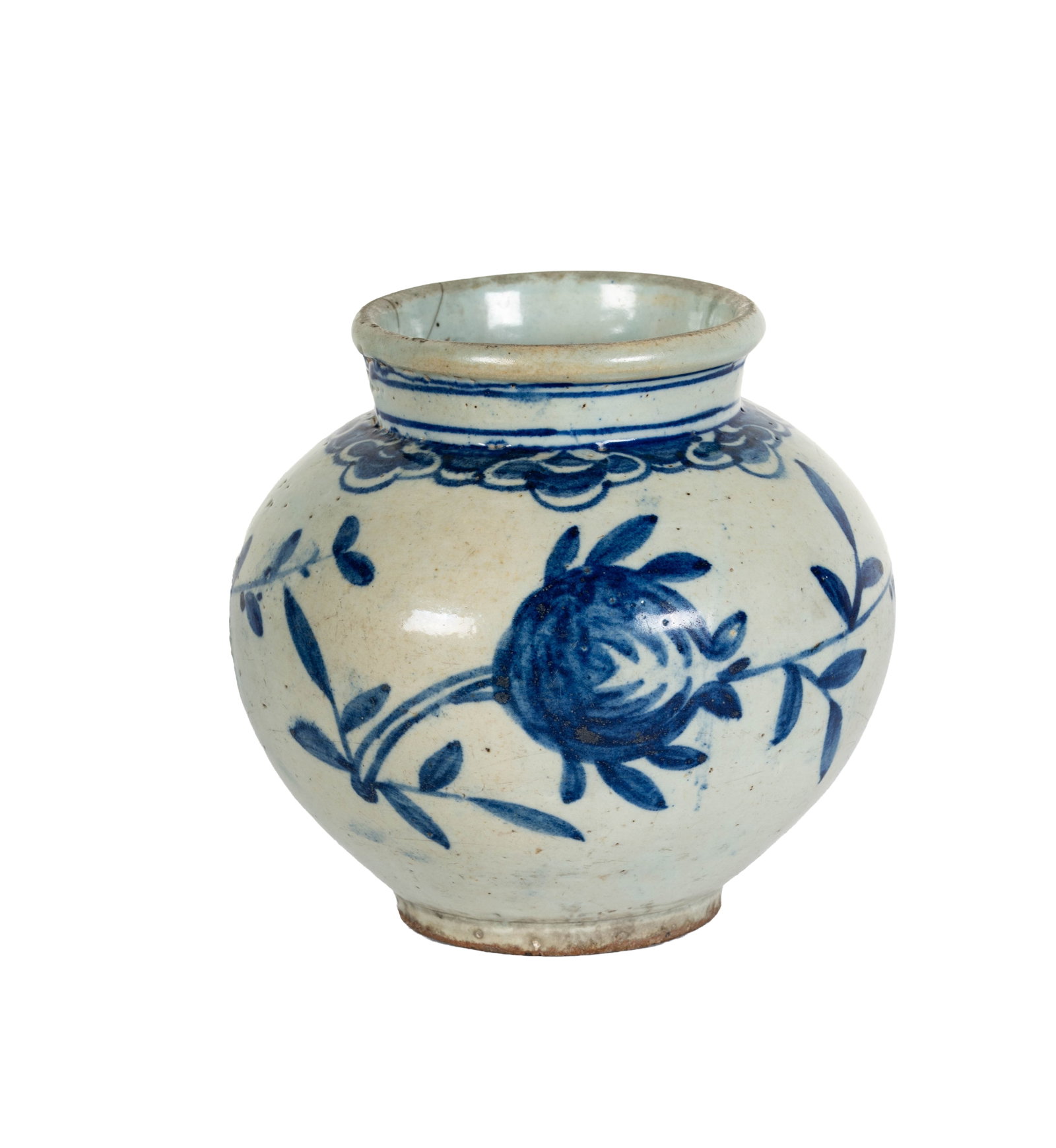 Blue and White Floral Decorated Pottery Vase: A white pottery vase with blue floral decoration. The vase has a round body and a slightly flared rim. The decoration consists of stylized flowers and leaves. There is a crack on the rim. 7 x 7 1/2 x 