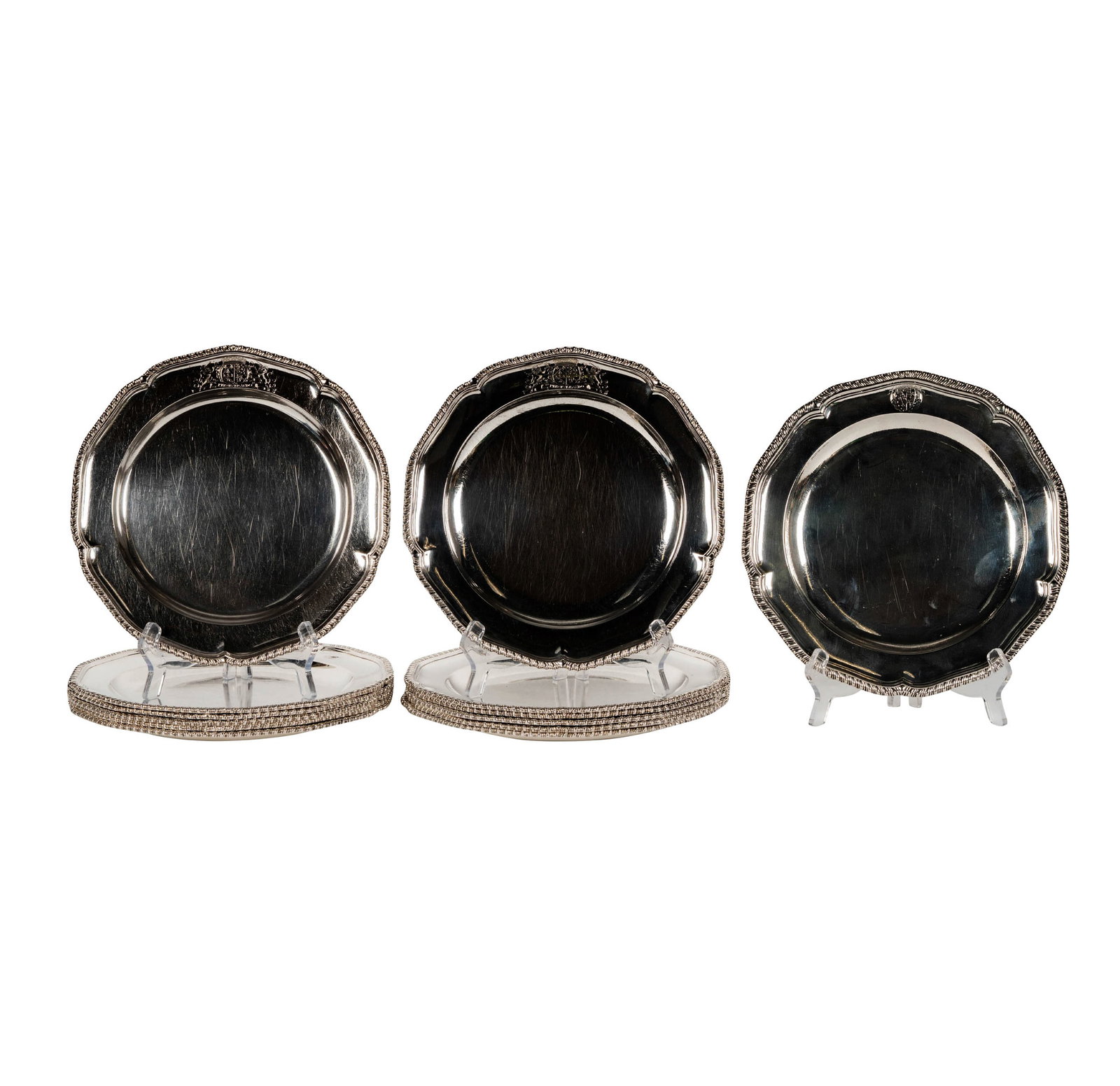 A Set of Thirteen George III Sterling Dinner Plates: comprising 12 marked for Francis Butty and Nicholas Dumee, London, 1770, and one in a matching pattern marked for Orlando Jackson, London, 1772; each engraved to rim with a heraldic crest; approximate