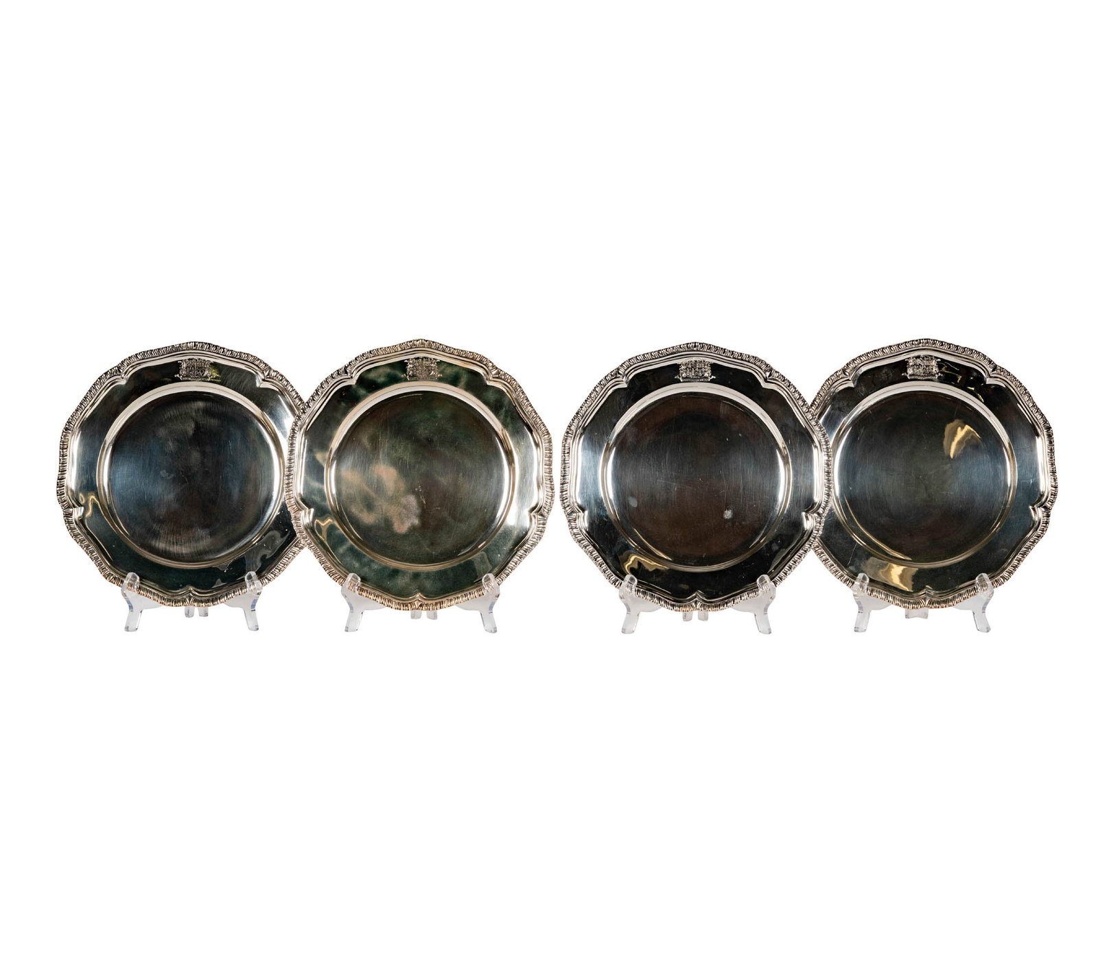 A Set of Four George III Sterling Plates by Paul Storr: Paul Storr, London, 1808, each marked to underside and engraved to top rim with an heraldic crest and with motto "Recte et suaviter", approximately 2813 grams total, each 10 1/2 dia.