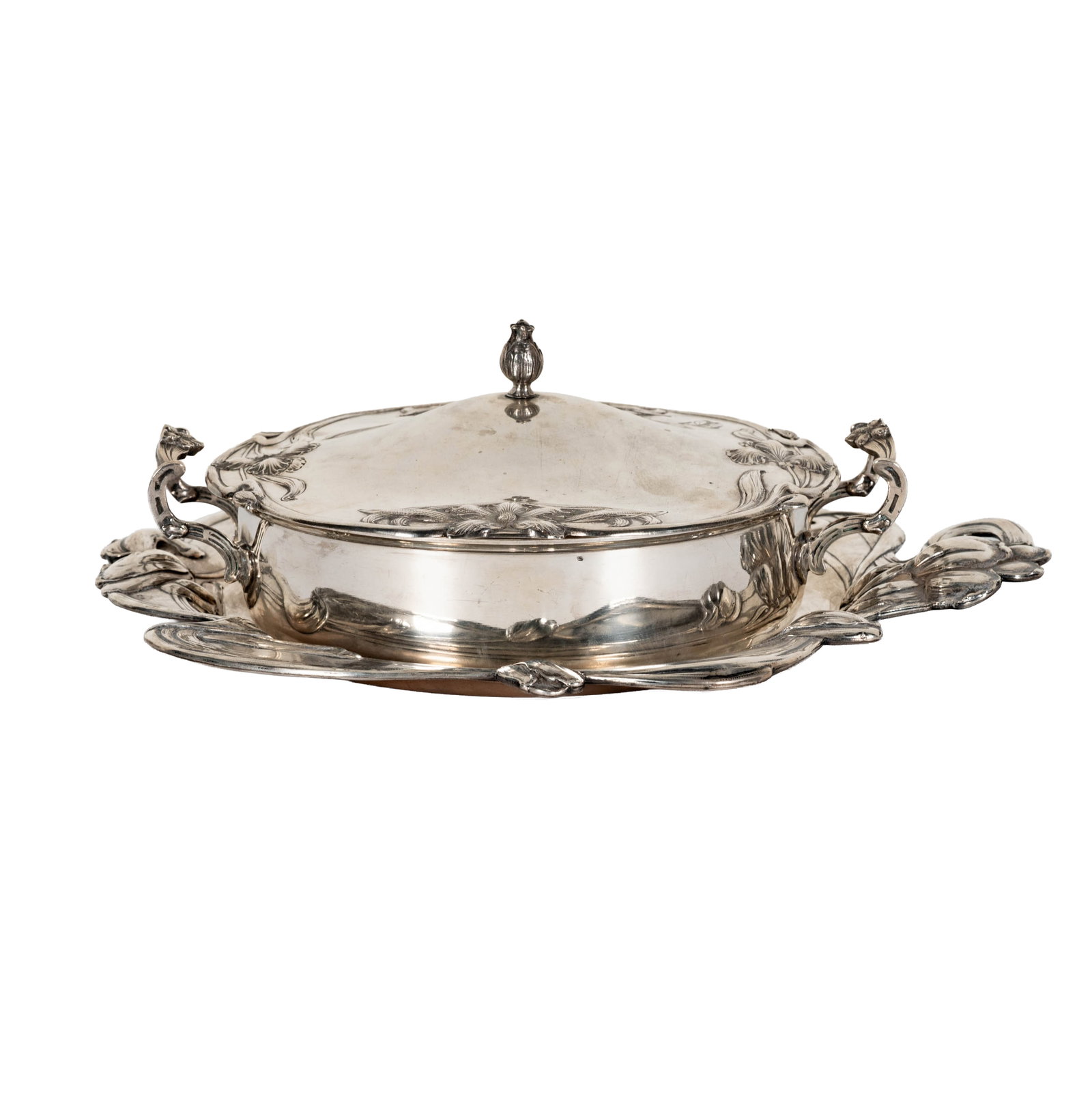 An Austrian Art Nouveau .800-Silver Covered Serving Dish and Tray: Vienna, 1872-1922, each piece engraved with a crest, each with Diana's head mark and illegible maker's mark; serving dish overall: 5 1/2 in. x 12 1/4 x 9 3/4 in. tray: 16 1/4 x 14 1/4 in., approximate