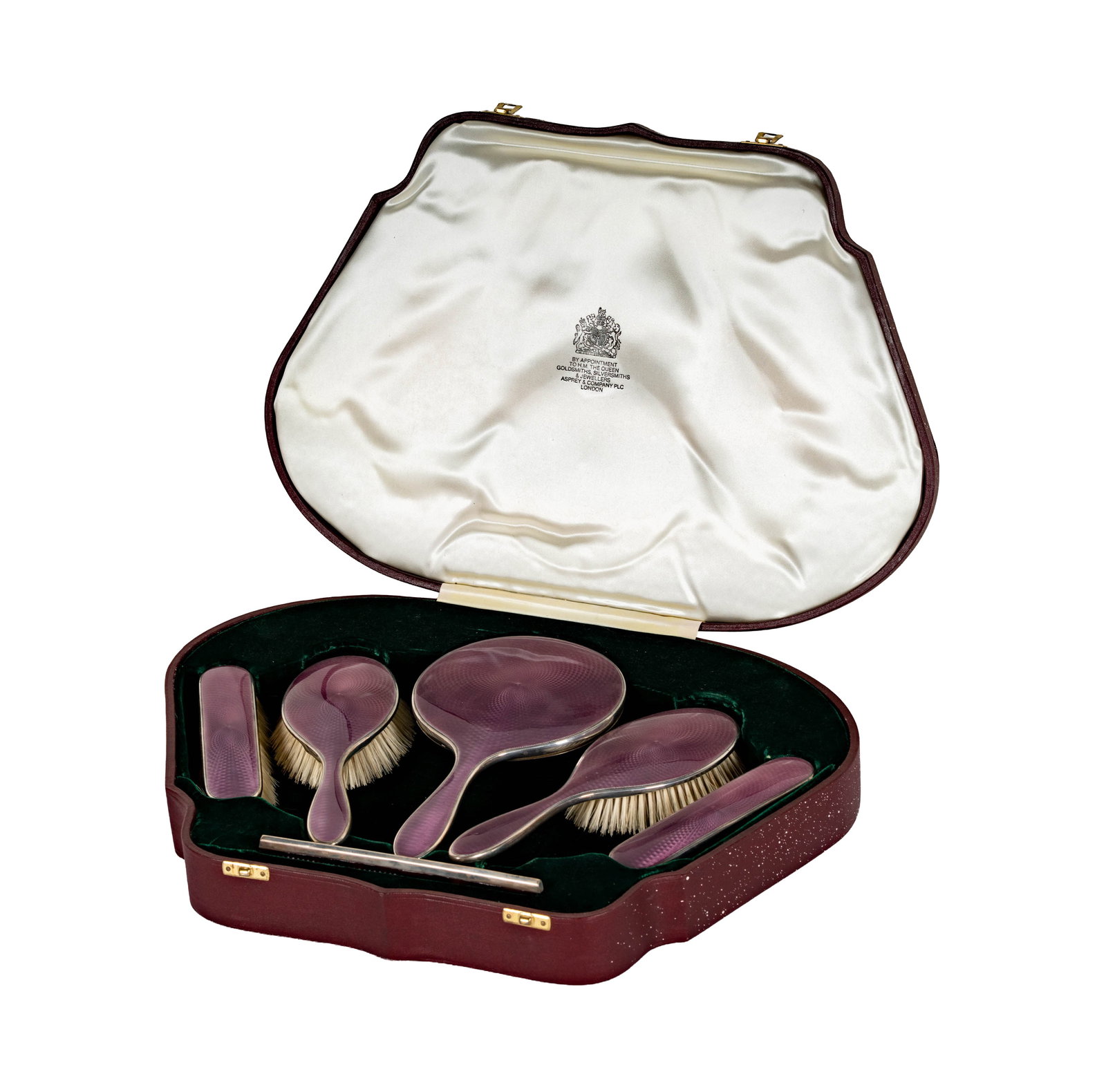 A George V Sterling and Guilloche Enamel Dresser Set Retailed by Asprey: retailed by Asprey and Co., maker's mark "B&S", Birmingham, 1925; comprising a hand mirror (10 1/8 in, x 5 3/8 in.), two brushes (each 9 x 3 in.), two flat brushes (each 6 1/4 x 1 1/2 in.), and a comb