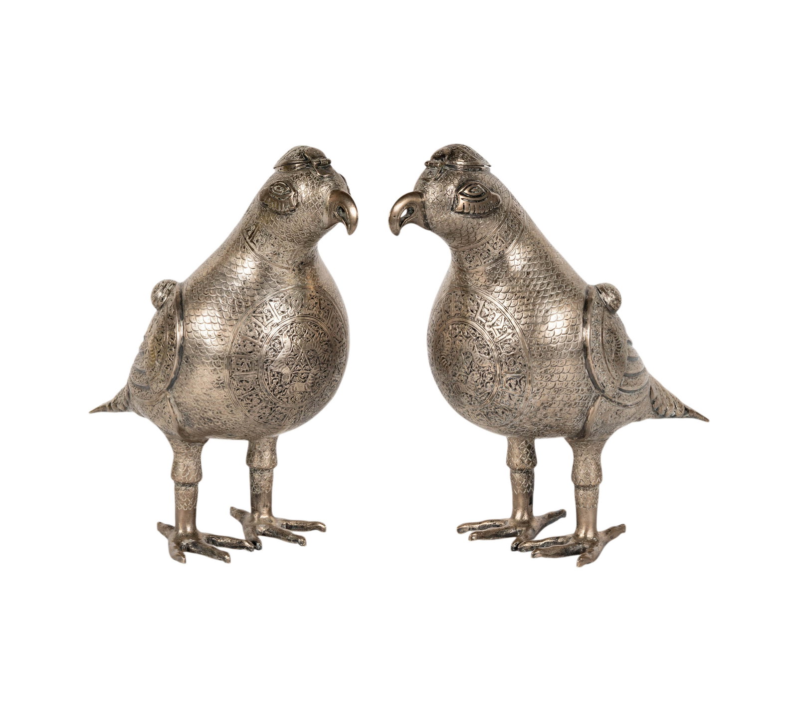 A Pair of Persian Silver Parrot Figures: each with incised decoration and hinged lid to top of head, each unmarked (tested for low grade silver content), approximately 3,414 grams total, each 11 x 10 1/2 x 5 in.