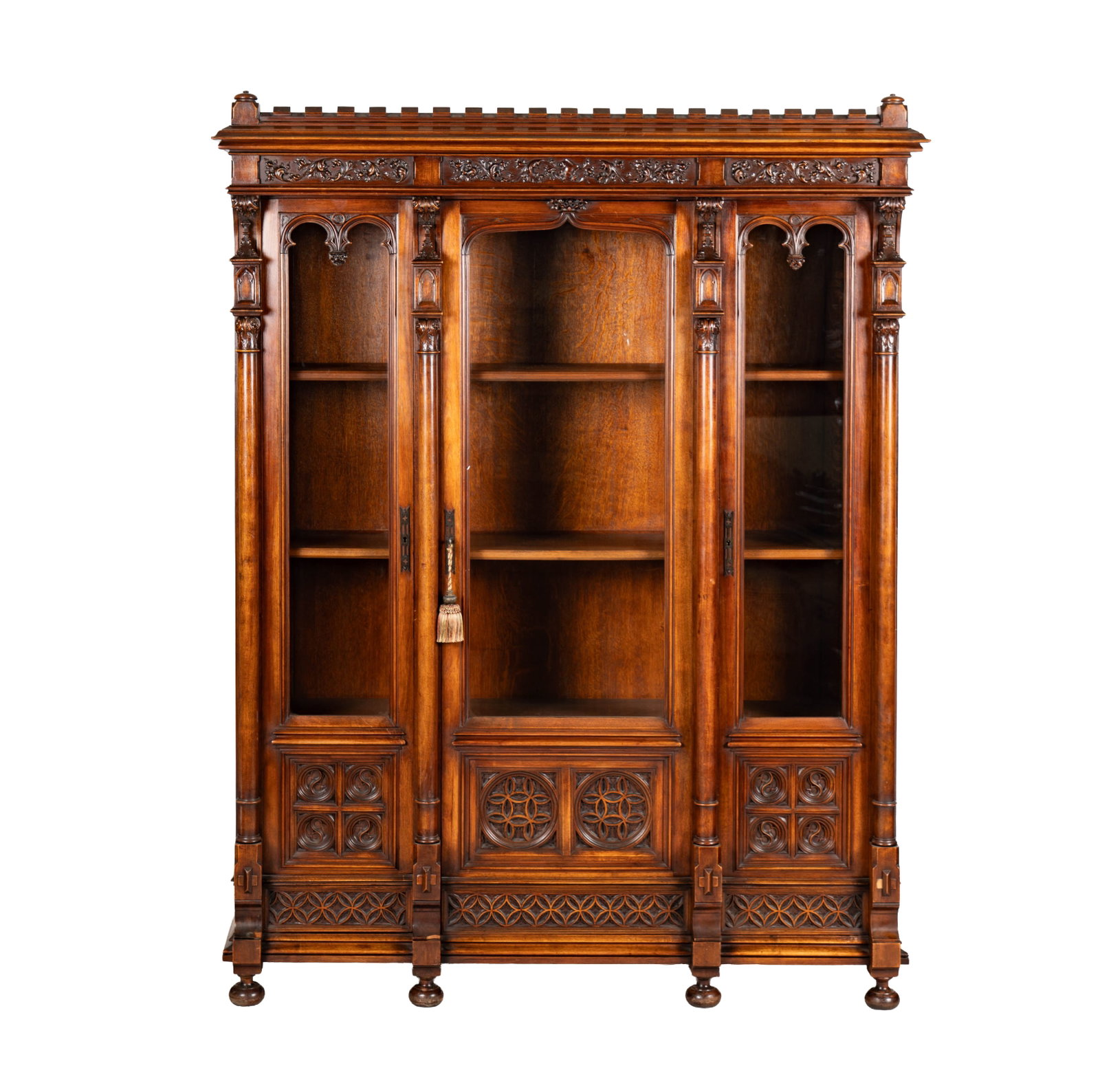 A Gothic Carved Wood Glass Front Bookcase: 19th century, includes key, 79 x 60 1/2 x 21 in.