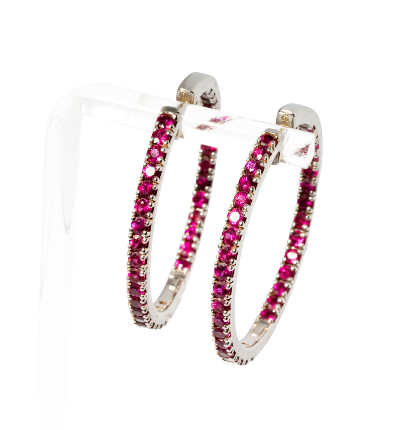 18 Karat White Gold and Ruby Hoops: Including one pair of 18 karat white gold ruby earrings, set with 64 round rubies weighing approximately 3.20 carats; earrings measuring 1-7/16 inches tall and weighing 17.5 grams;
